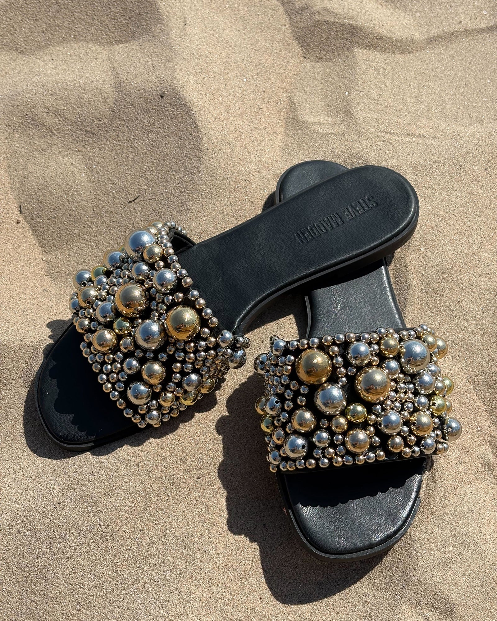 Close-up of the detailed ornaments on KLIO womens slide sandals