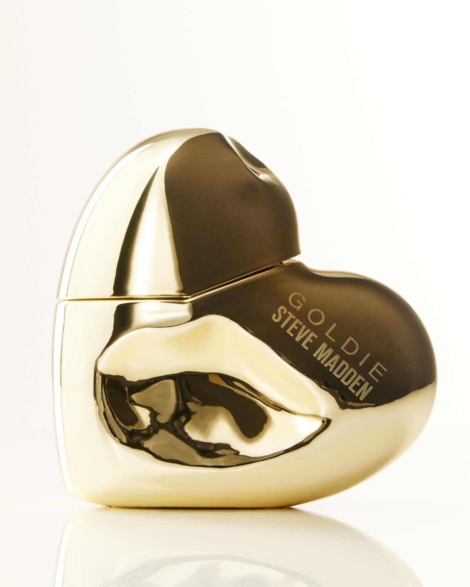 Goldie women's designer perfume bottle with floral notes in a sunny setting.