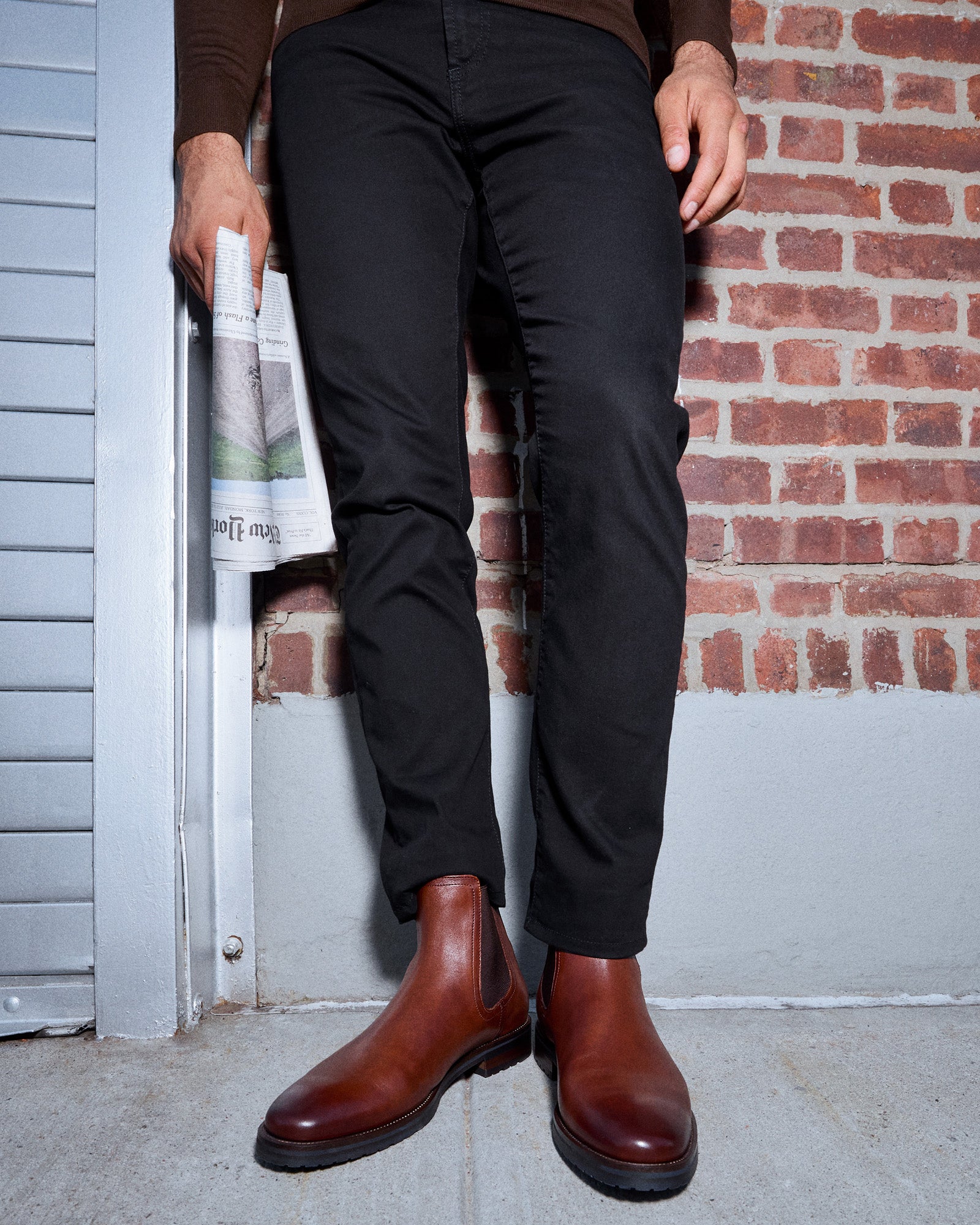 Front view of SYRE tan leather pull-on boots on a city street