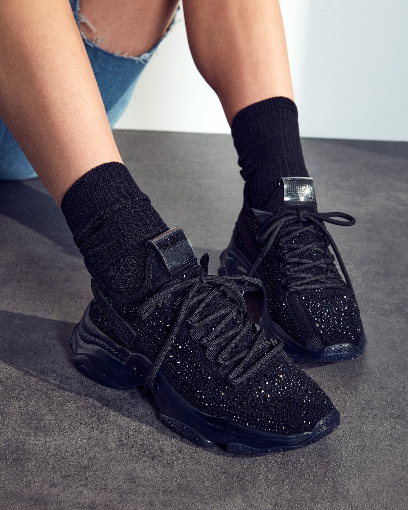 Comfortable lace-up design of the black rhinestone sneakers.