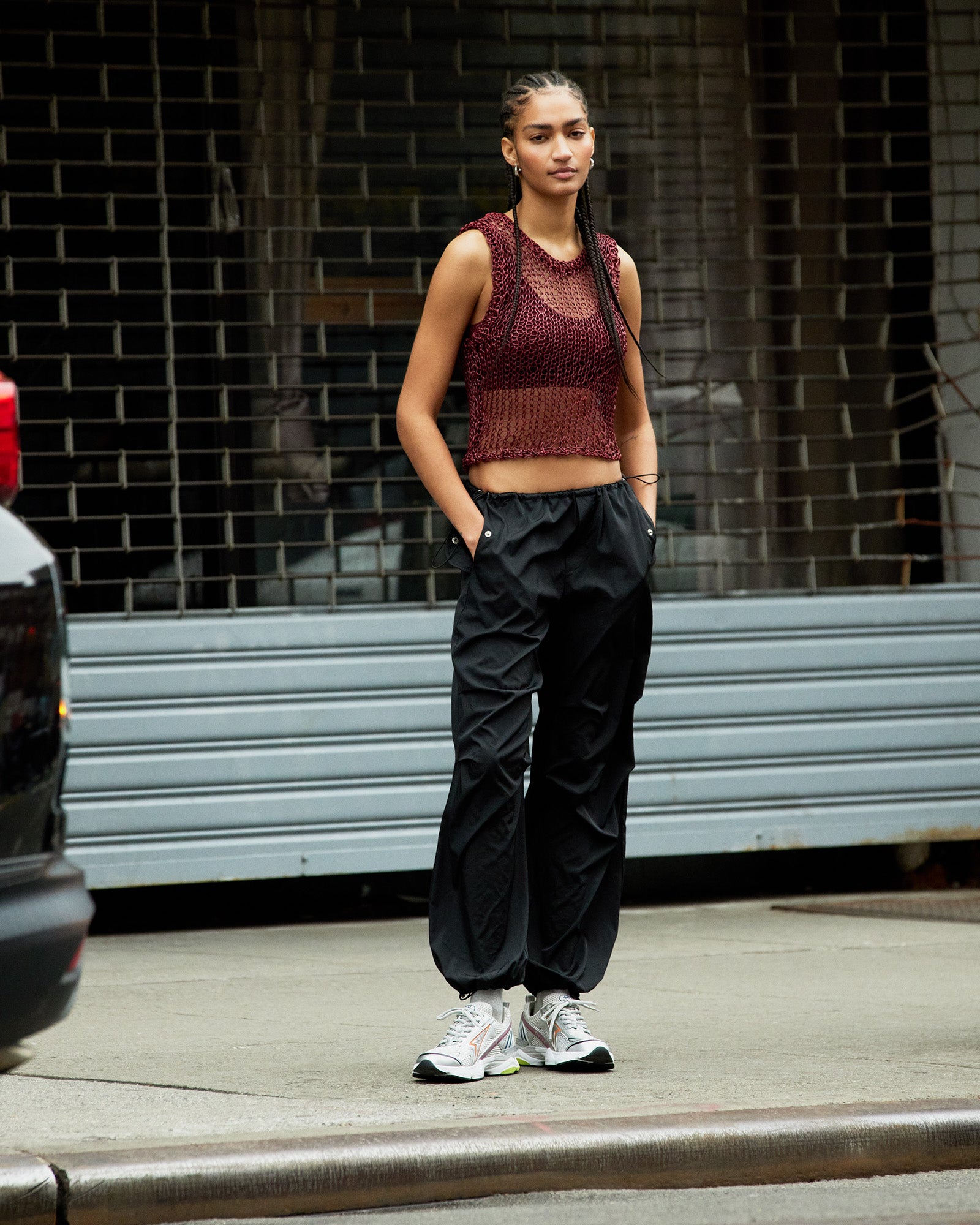 Side view of PIA parachute pants highlighting the adjustable drawstring feature.