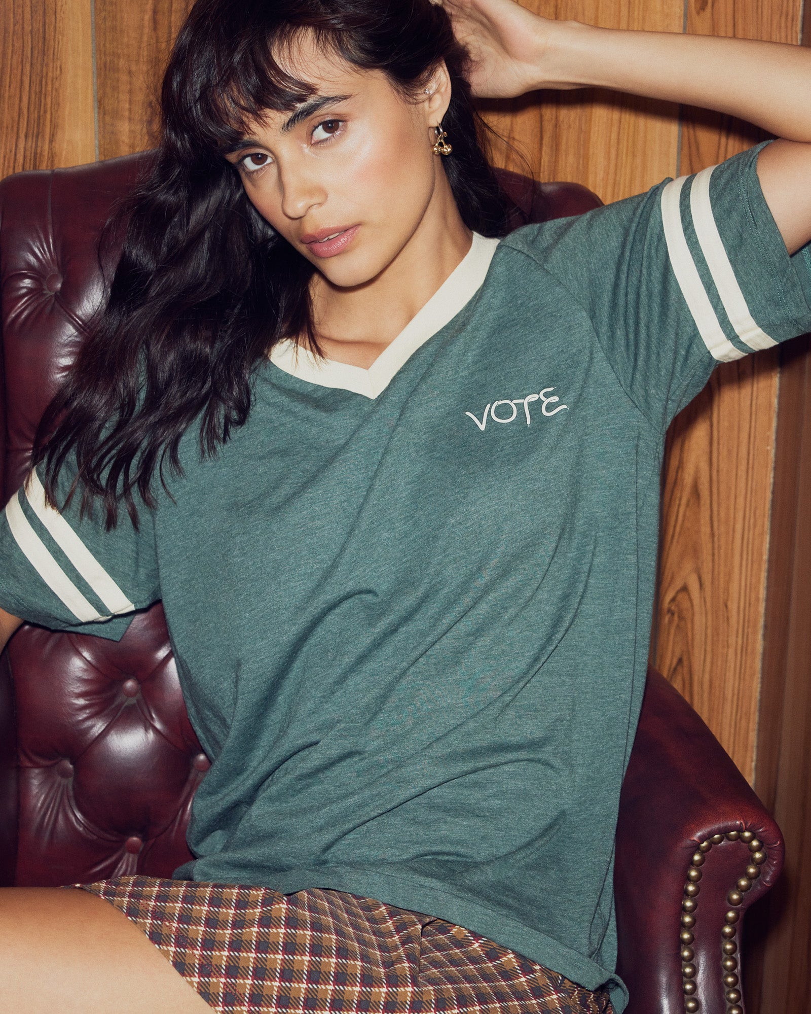 Back view of the green Vote t-shirt highlighting the locker loop for easy hanging.