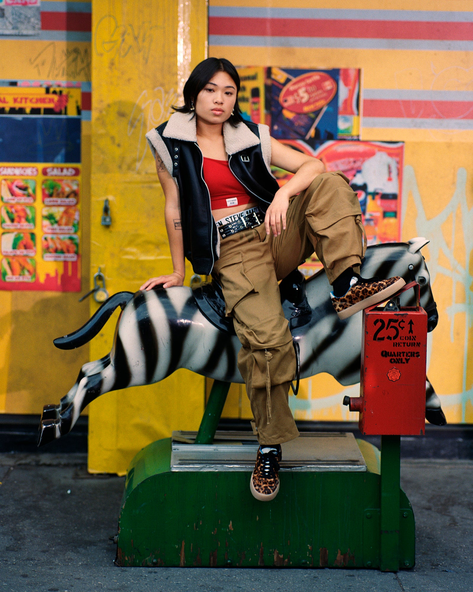 Side profile of white sneakers with leopard accents, shown with urban streetwear