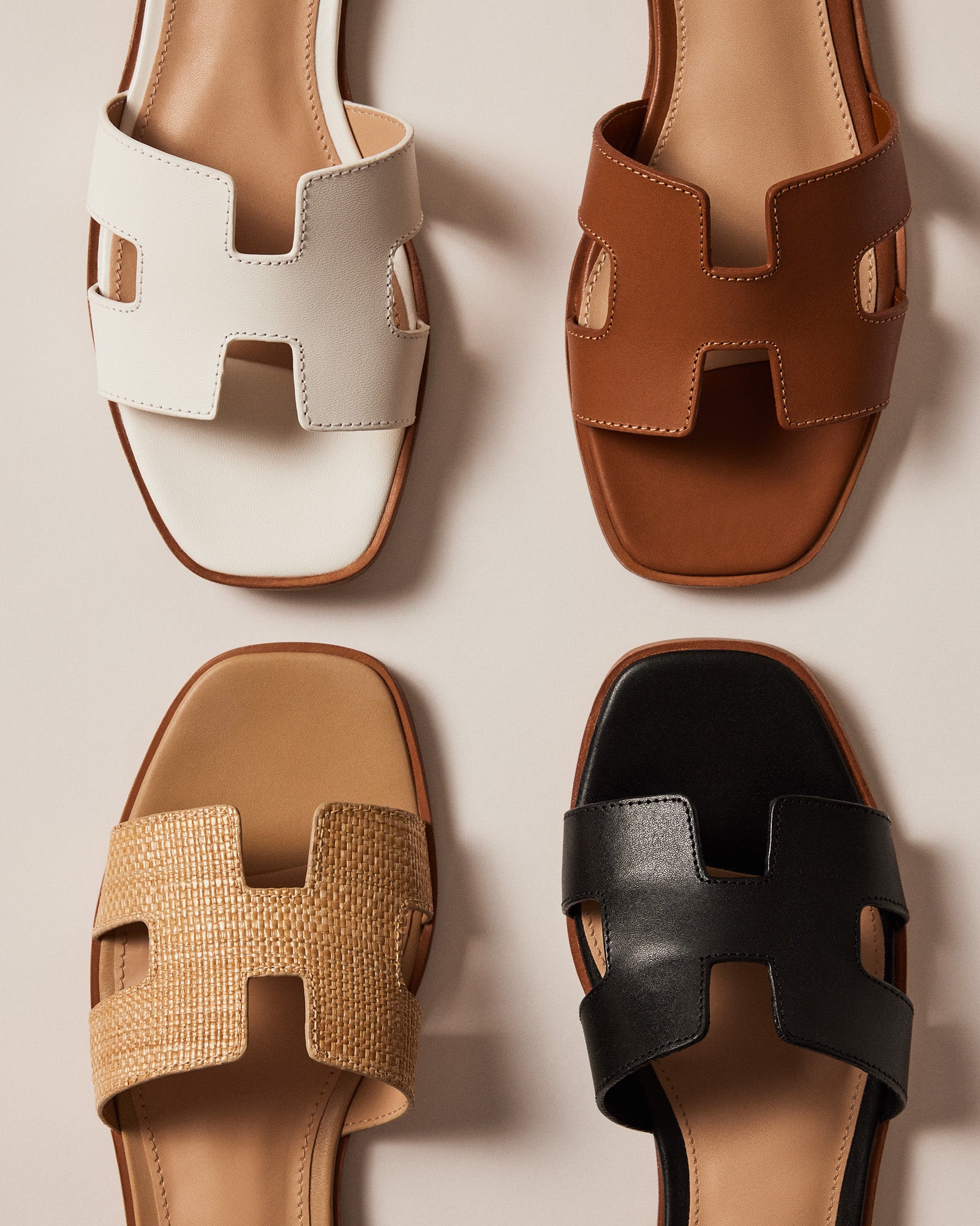 Hayden white leather sandals showcasing geometric cutouts from the side.