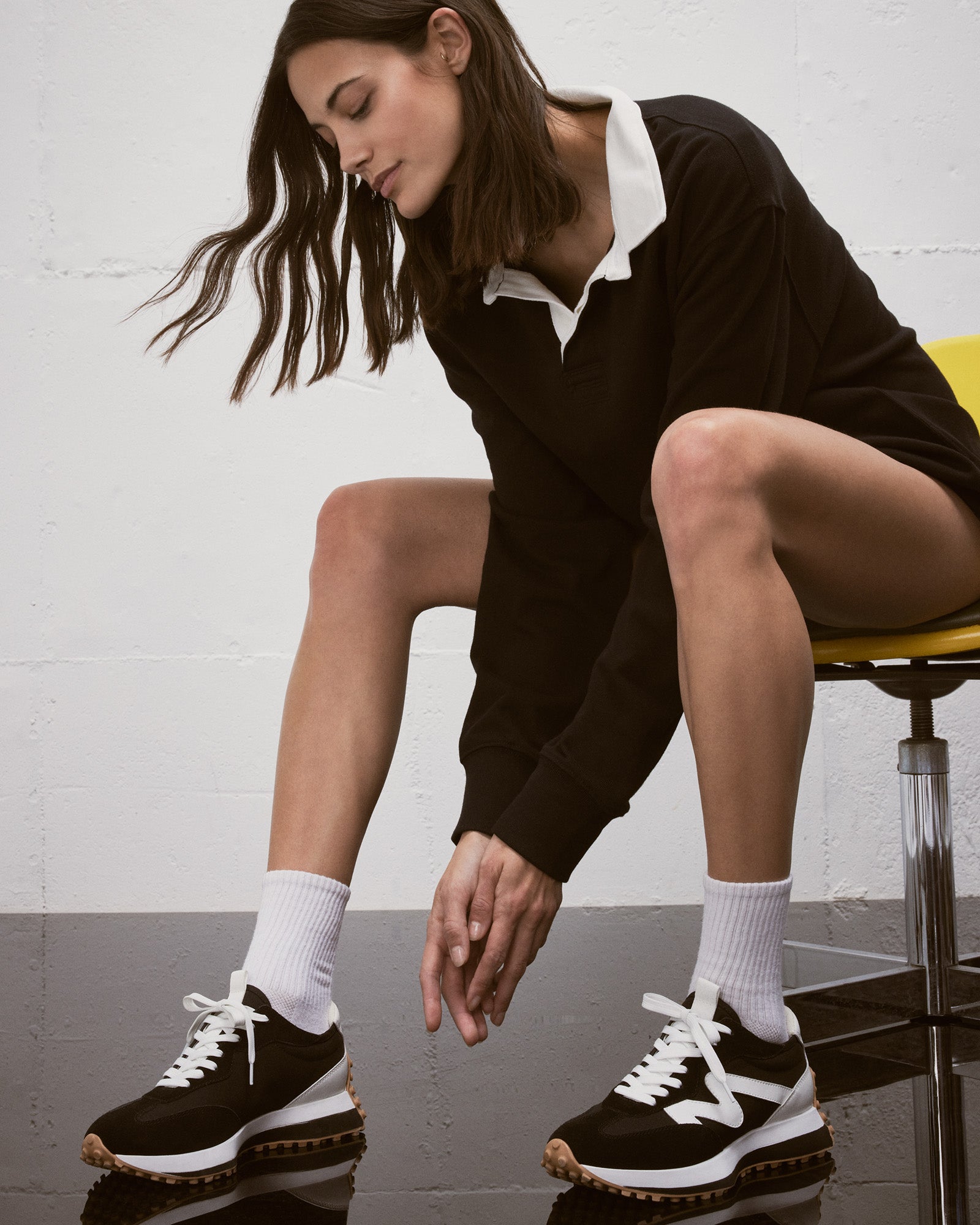 Side view of CAMPO black and white platform sneakers on pavement