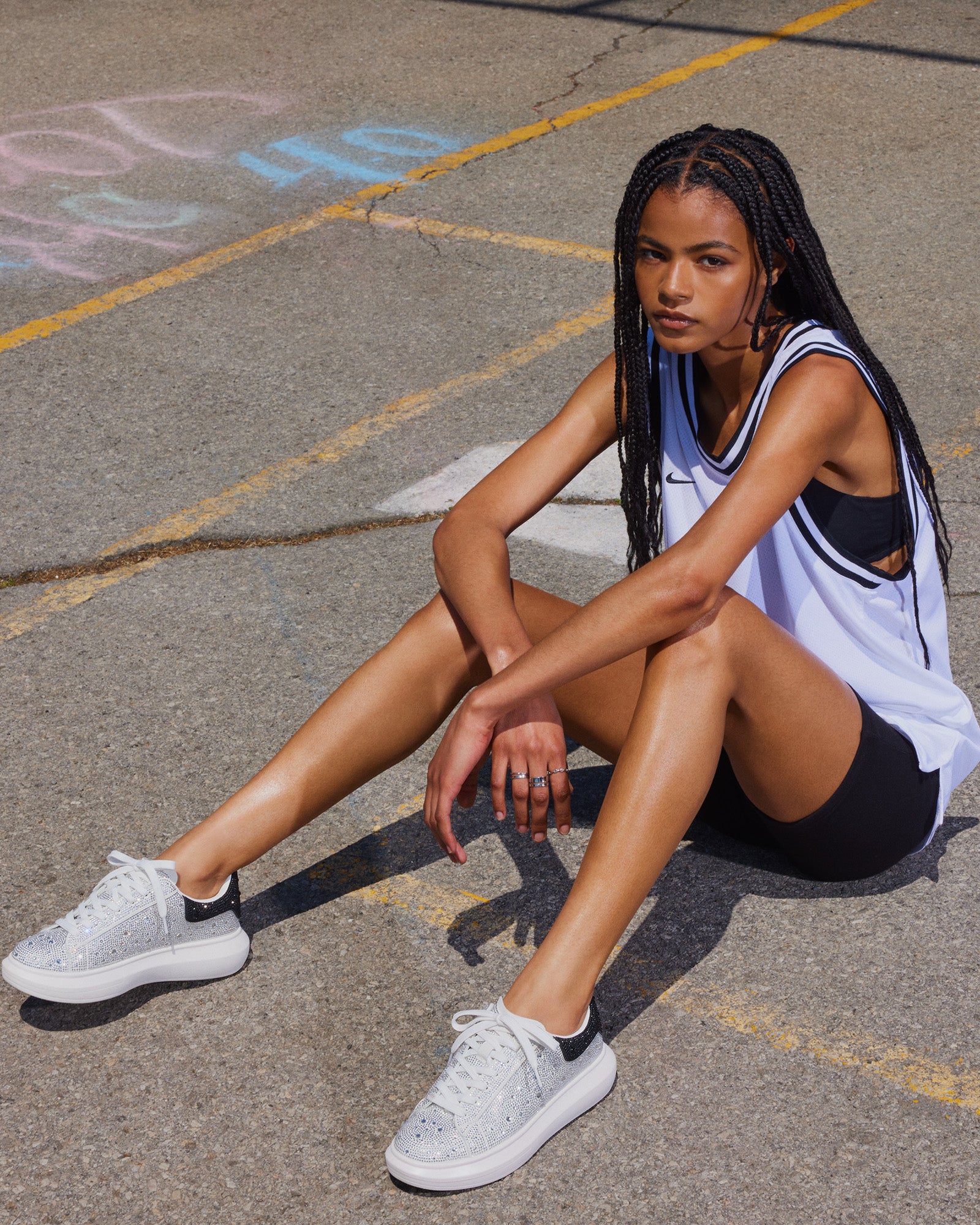 Close-up of rhinestone shoes on model standing in NYC streetwear