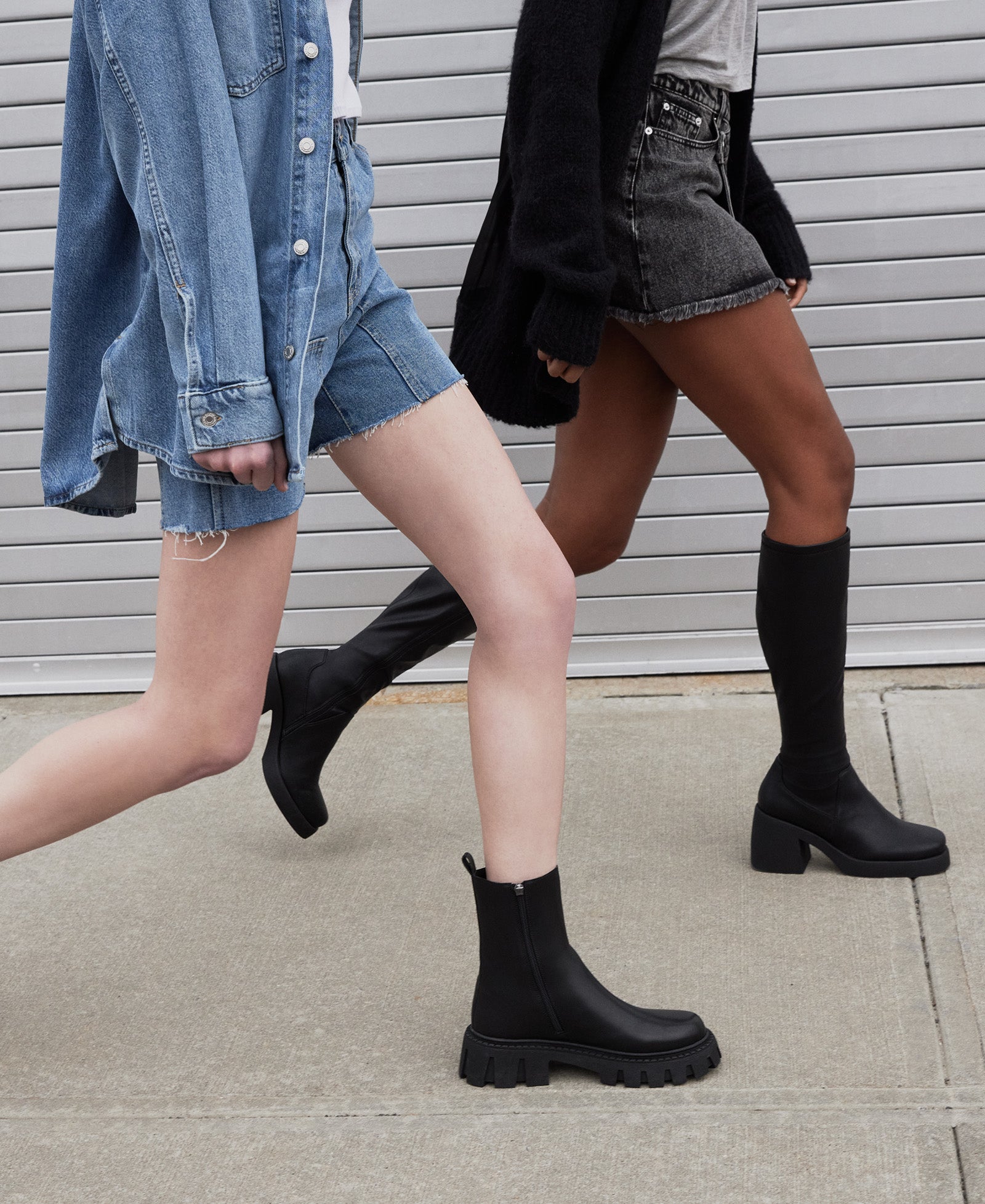 Side view of black leather Chelsea boots showcasing the elastic gore and zipper closure.