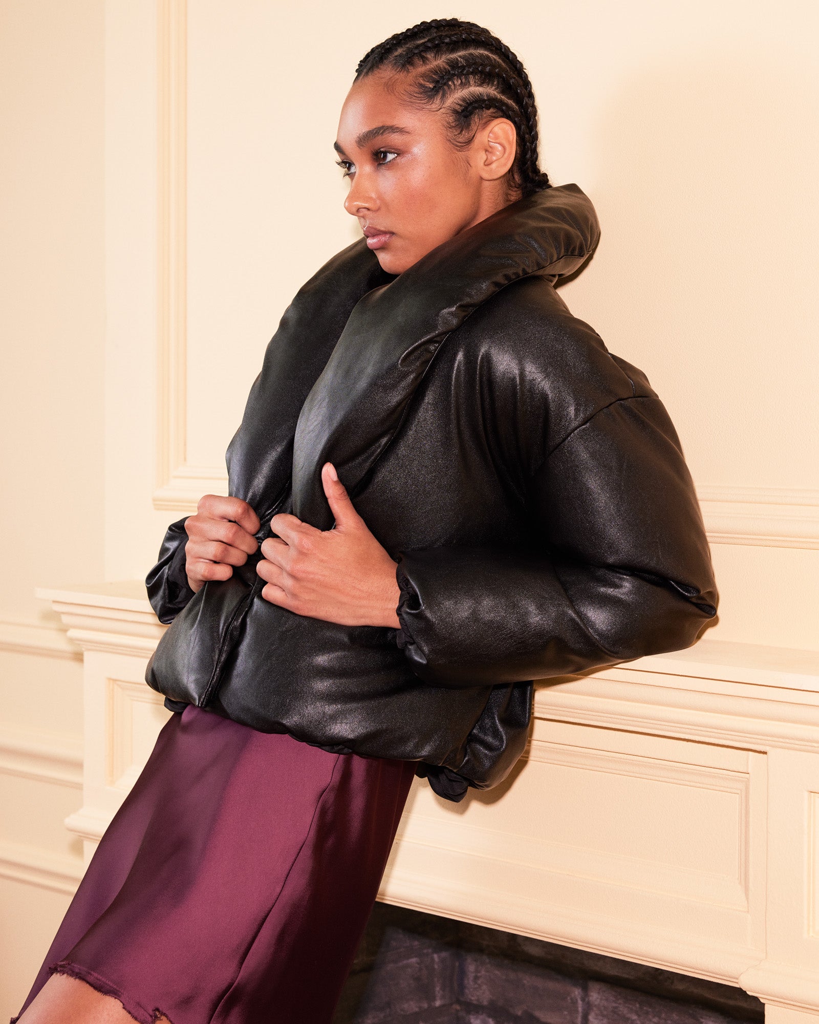Front view of the black vegan leather puffer jacket showcasing the shawl collar.