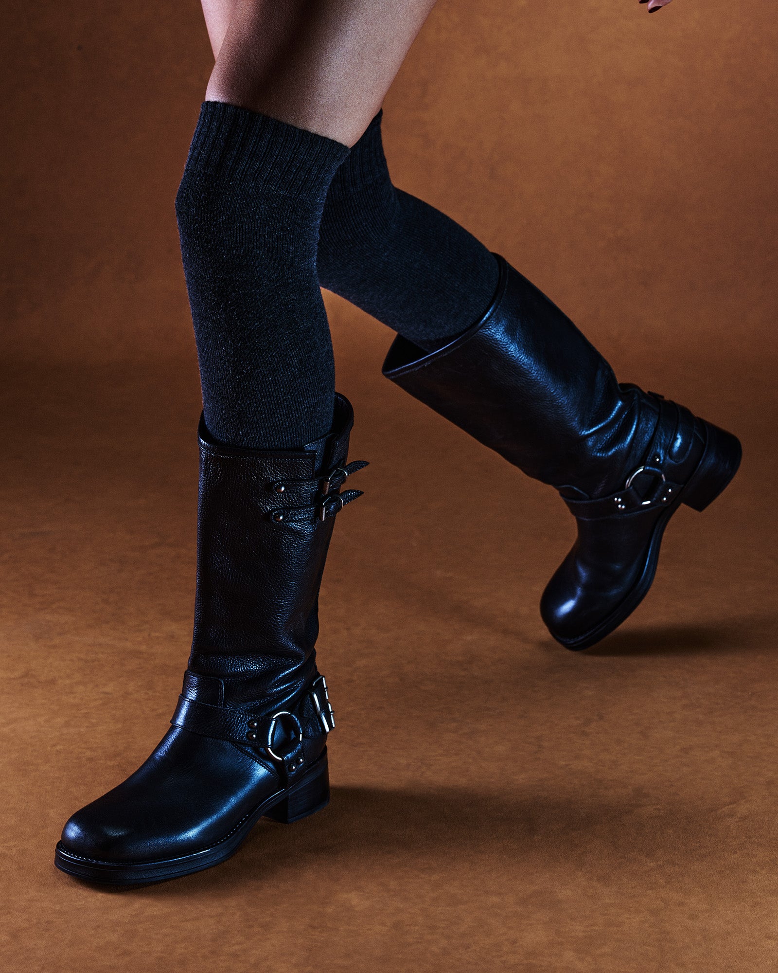 Side view of Astor black leather engineer boots with buckle straps and square toe