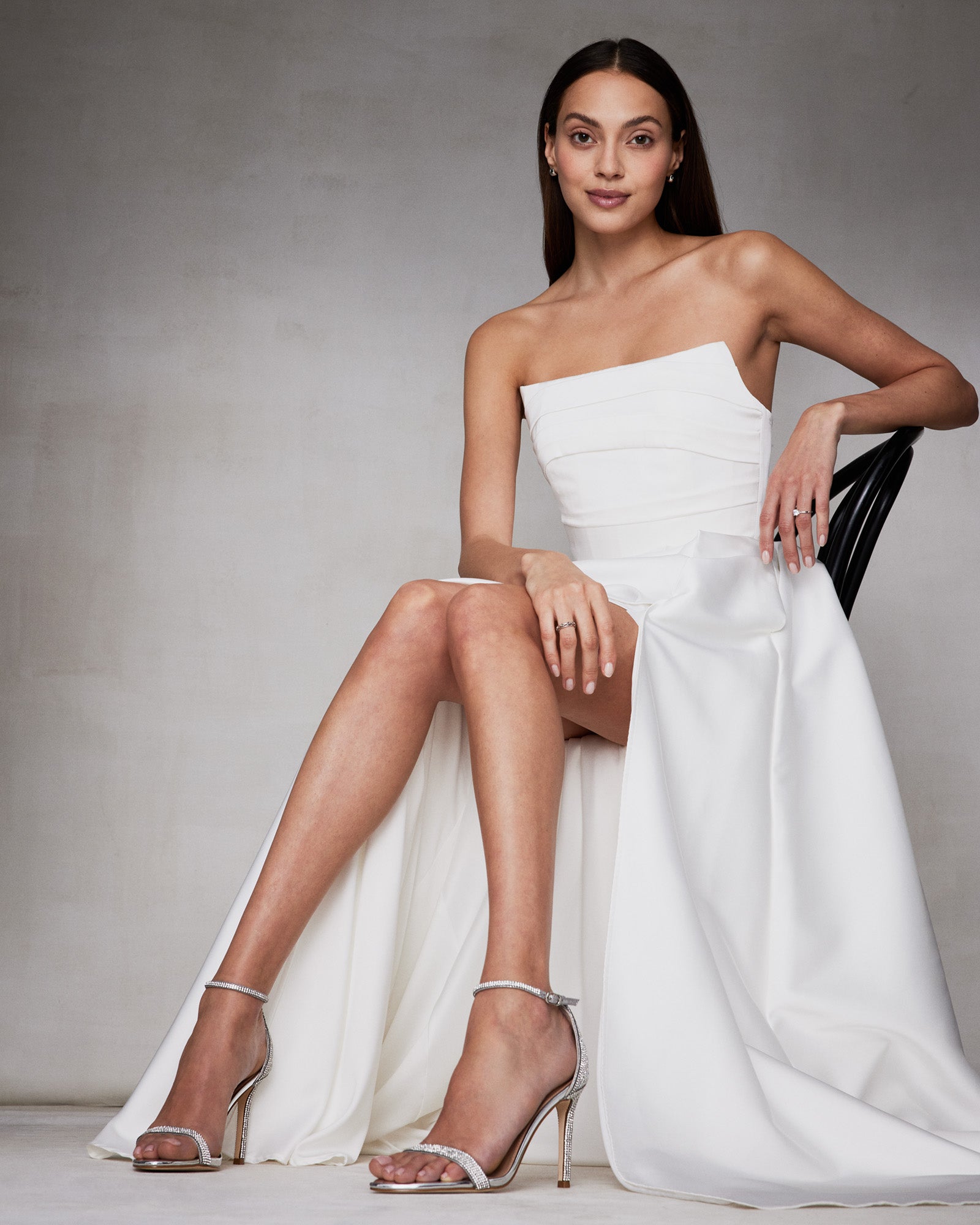 Tecy rhinestone sandals worn with a cocktail dress, showcasing the stiletto heel and sparkle.