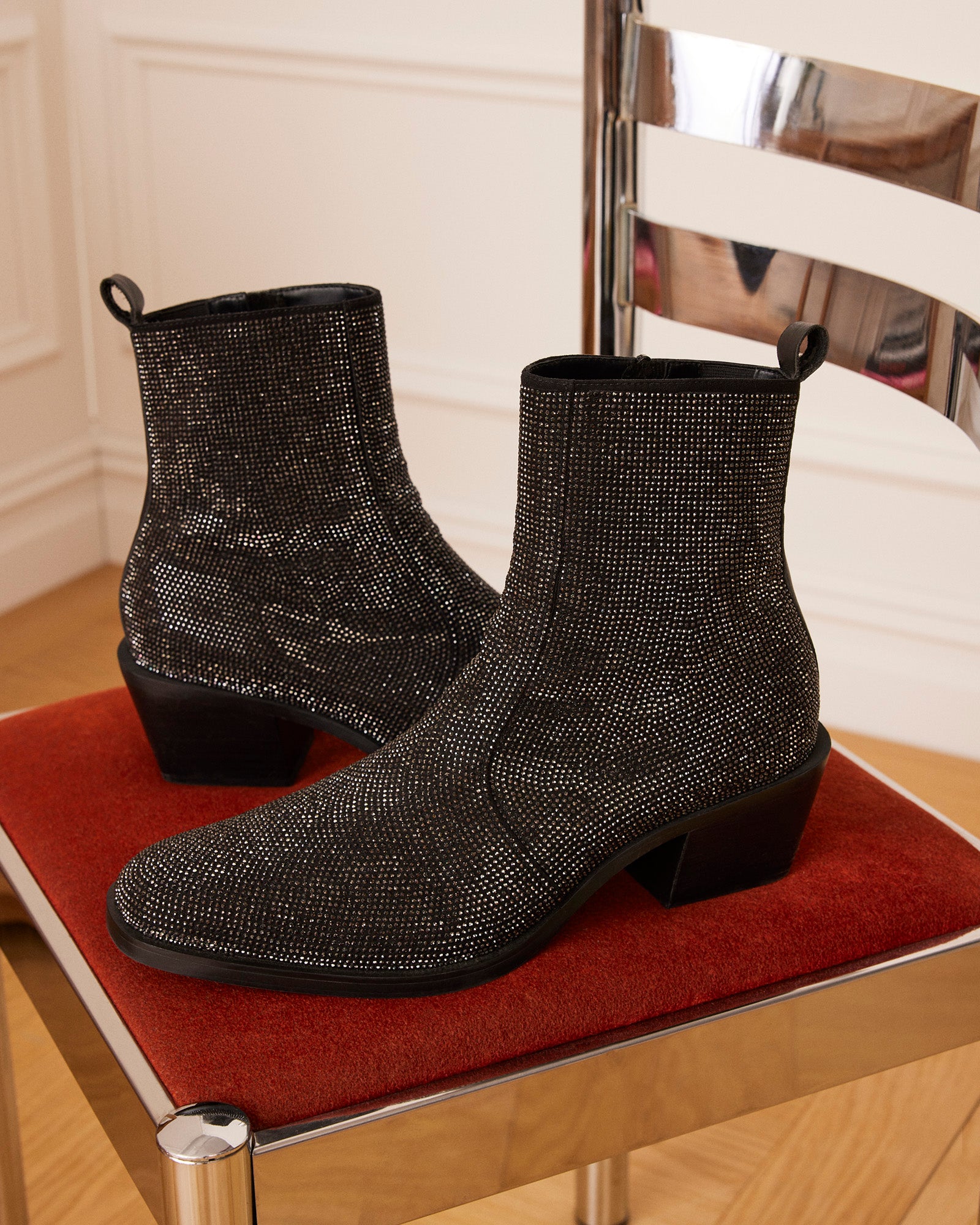 Side profile showing zipper closure on black womens ankle boots