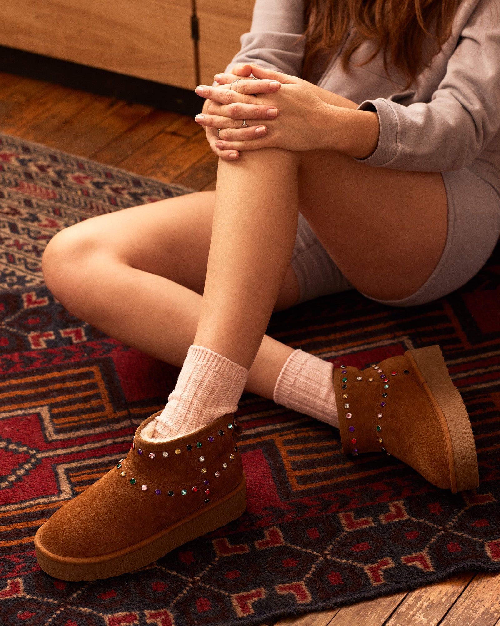 Close-up of rhinestone booties showing suede texture and embellishments