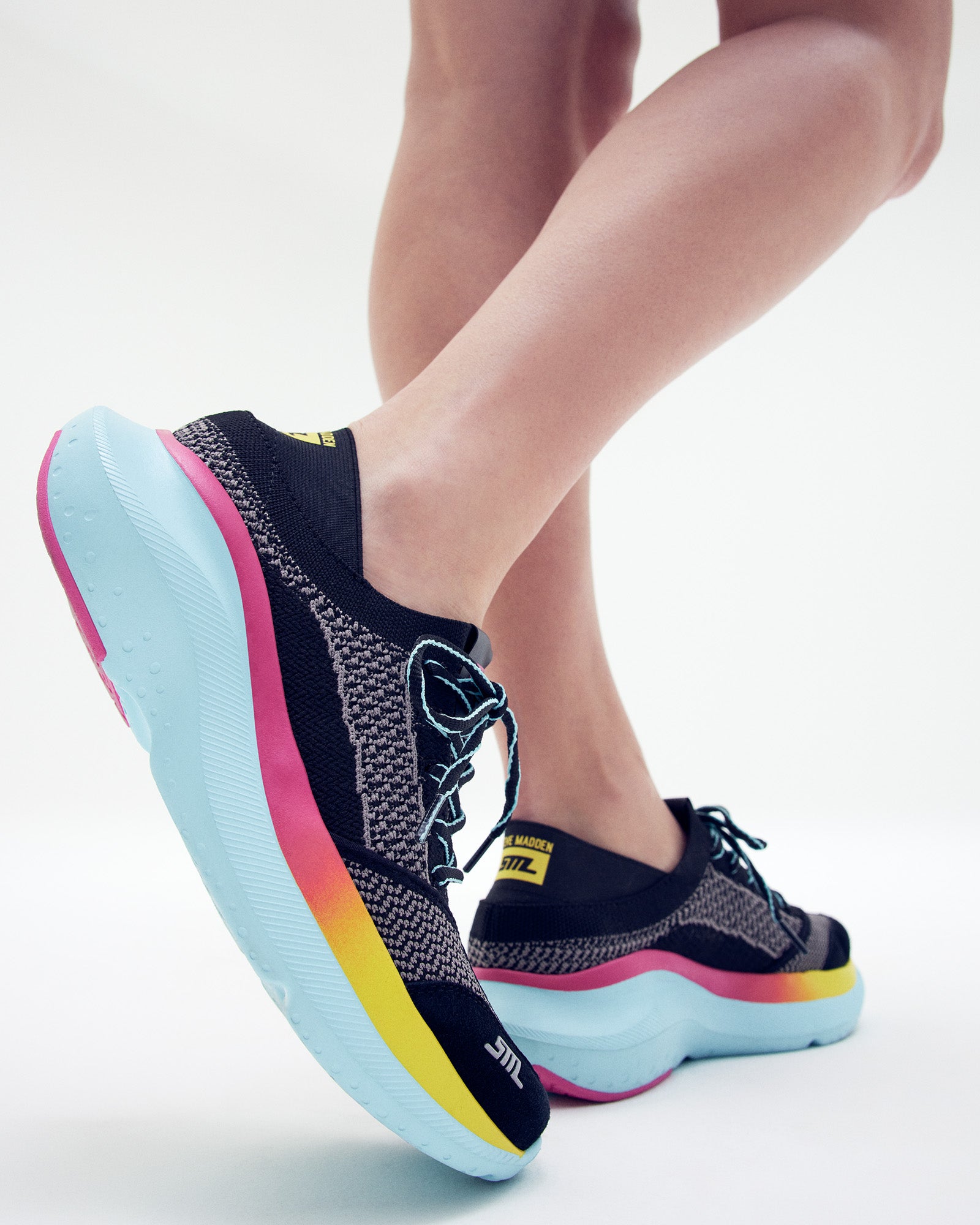 Side view of stylish black platform sneakers highlighting the 2-inch heel height.