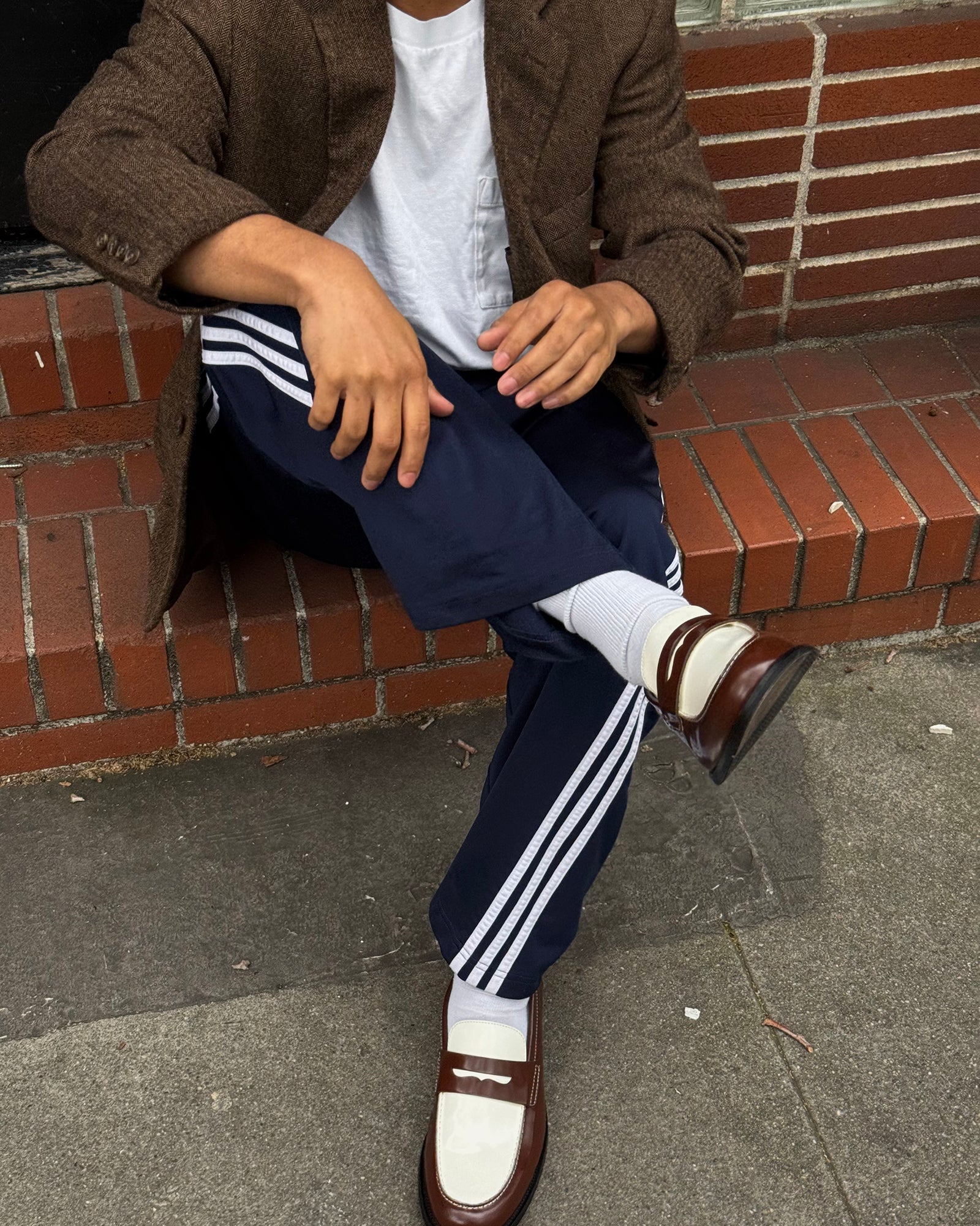 Three pairs of men's crew socks folded neatly, ivory color against neutral background.