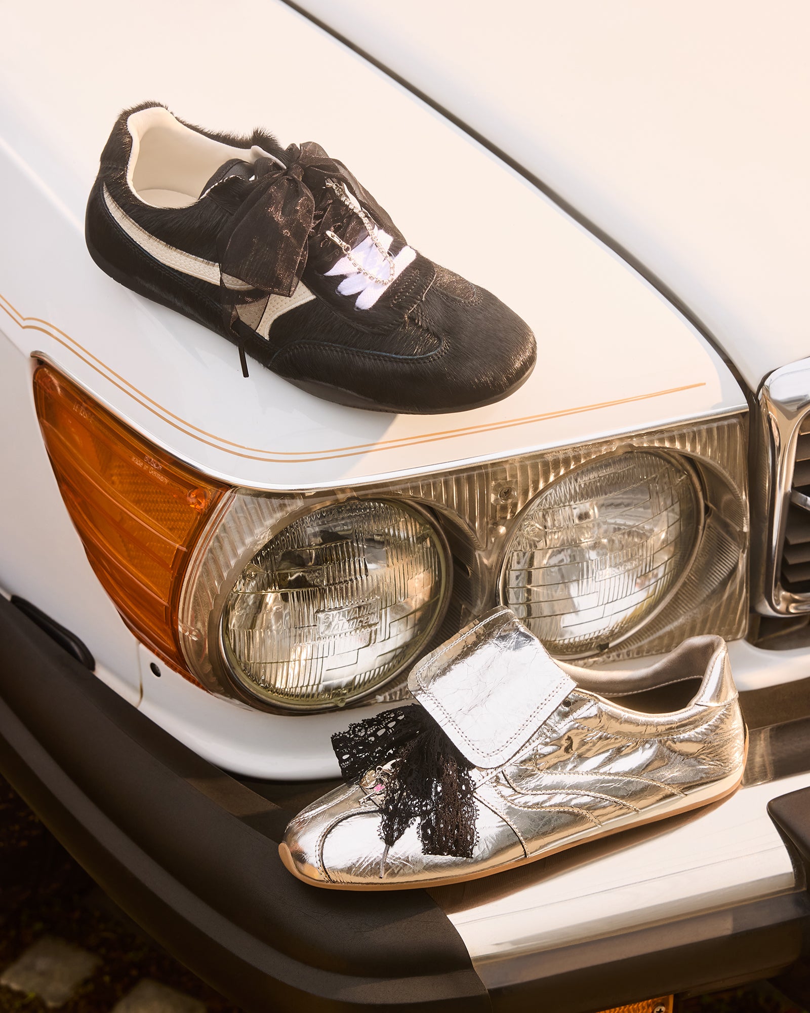 Close-up of black shoe charms featuring a pearl and rhinestones.
