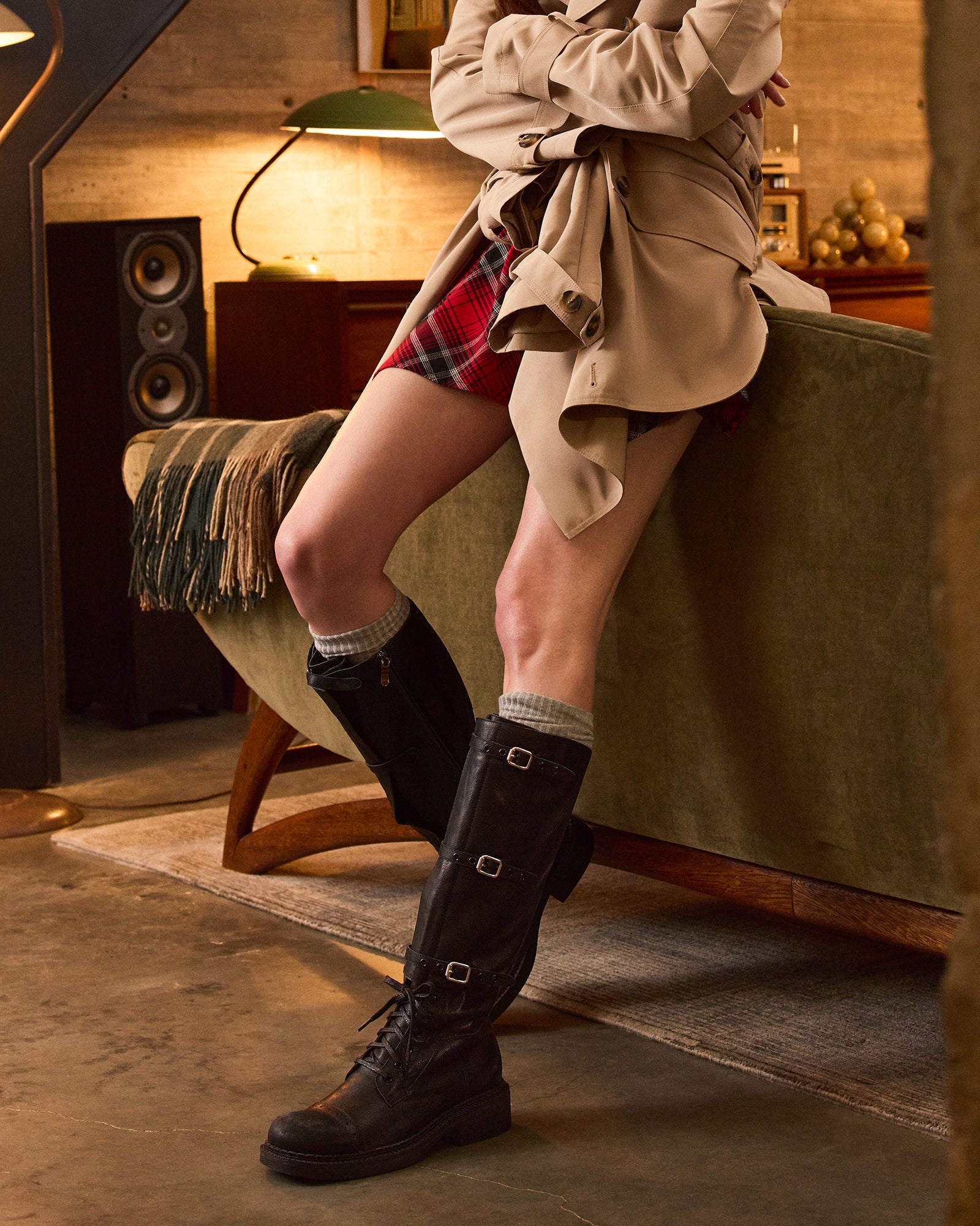 Model wearing chic black leg warmers in a dance studio setting.
