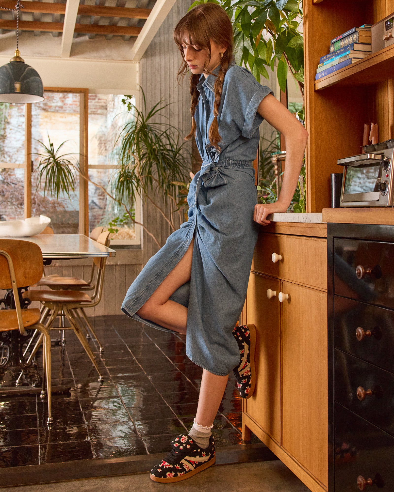 Front view of denim dress styled with flats, ideal for daily city wear