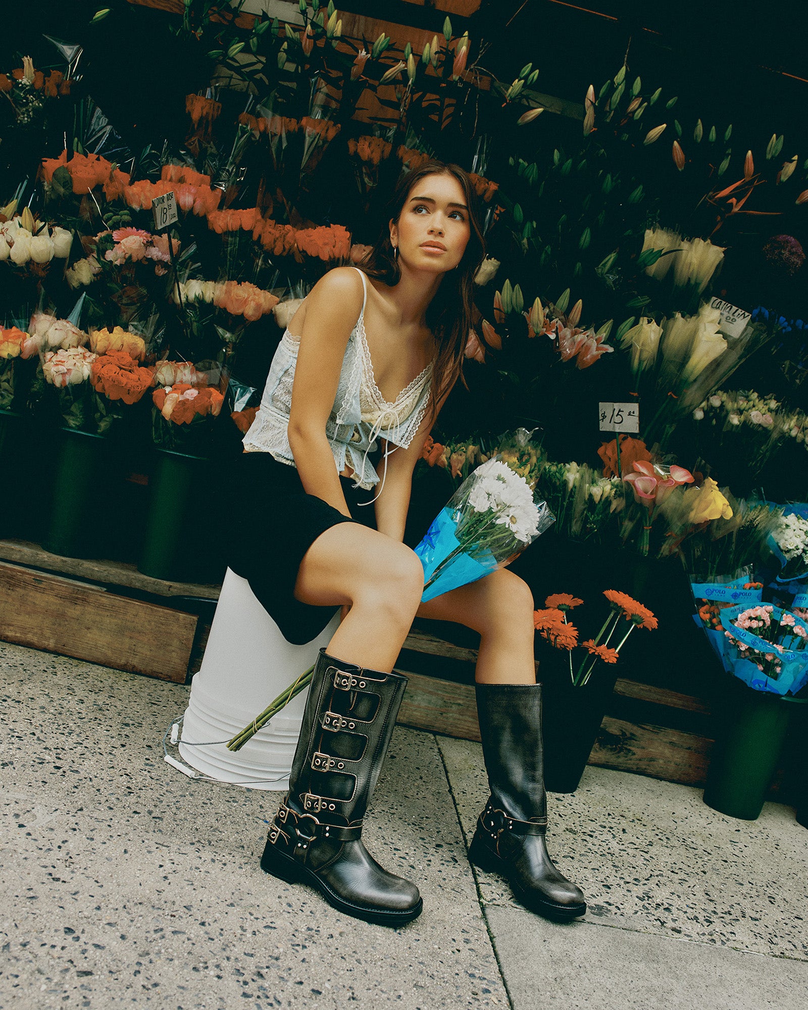 Close-up of distressed leather knee boots with buckle hardware and heel detail