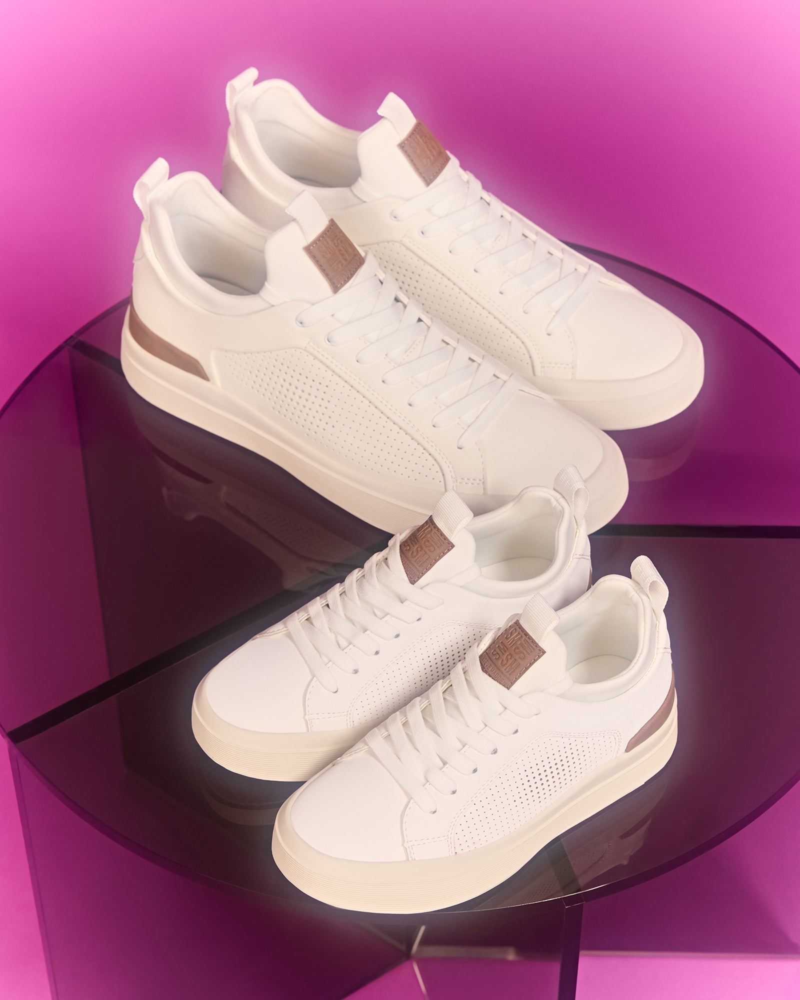Top view of white platform sneakers for kids on a rustic wooden bench