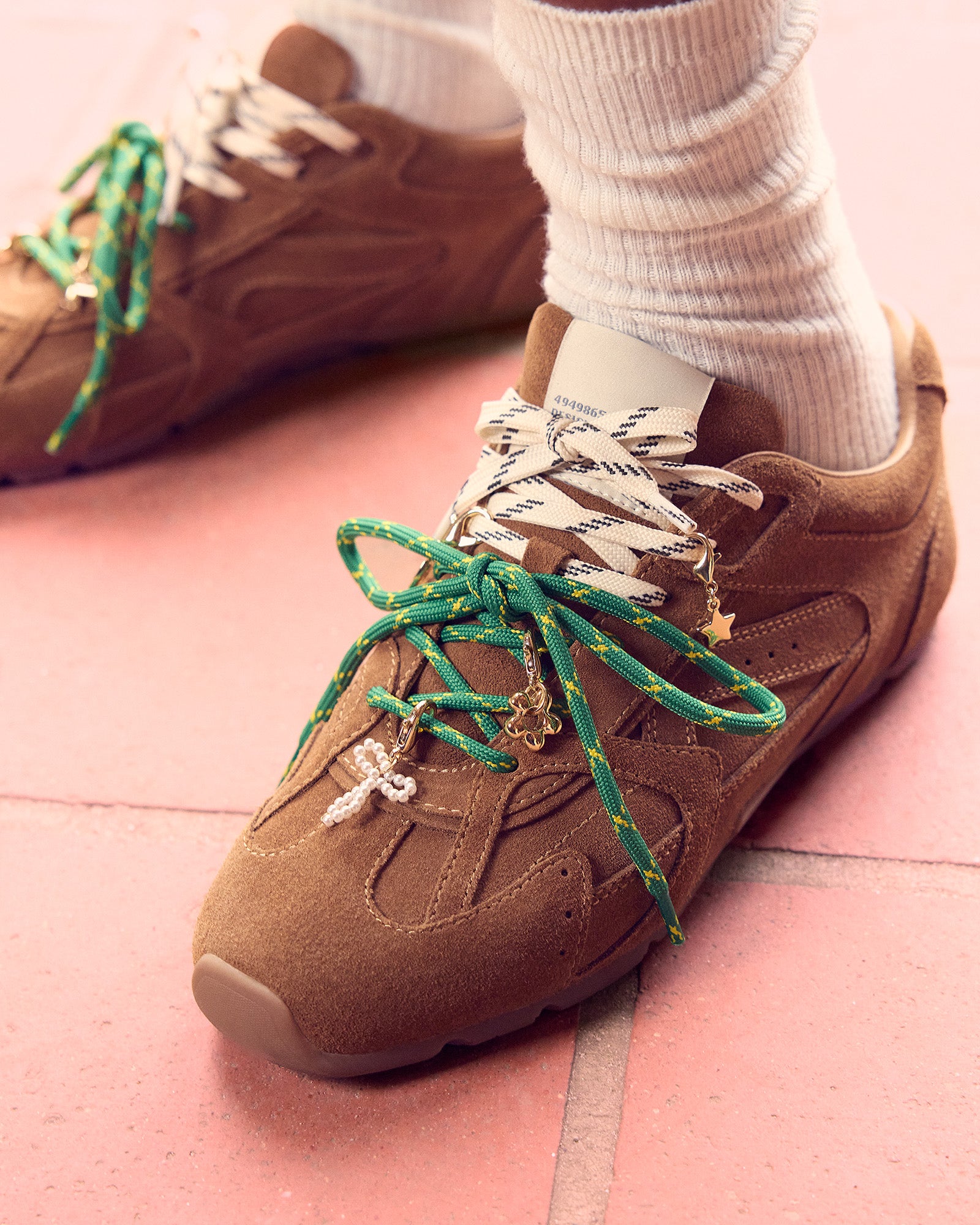 Person wearing Aziel sneakers with jeans for a styled look