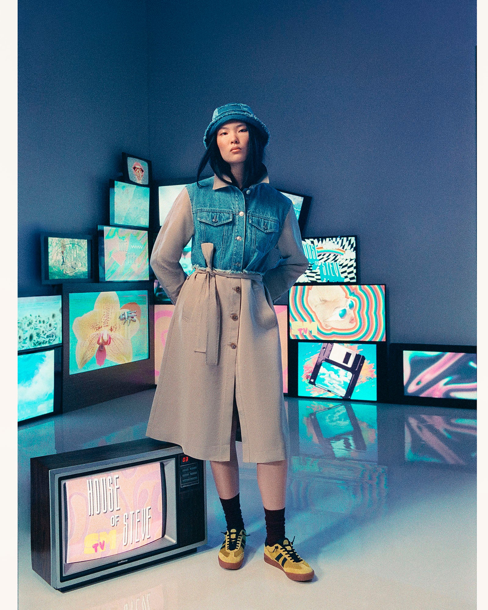 Back view of womens outerwear coat highlighting denim patchwork and button detail.