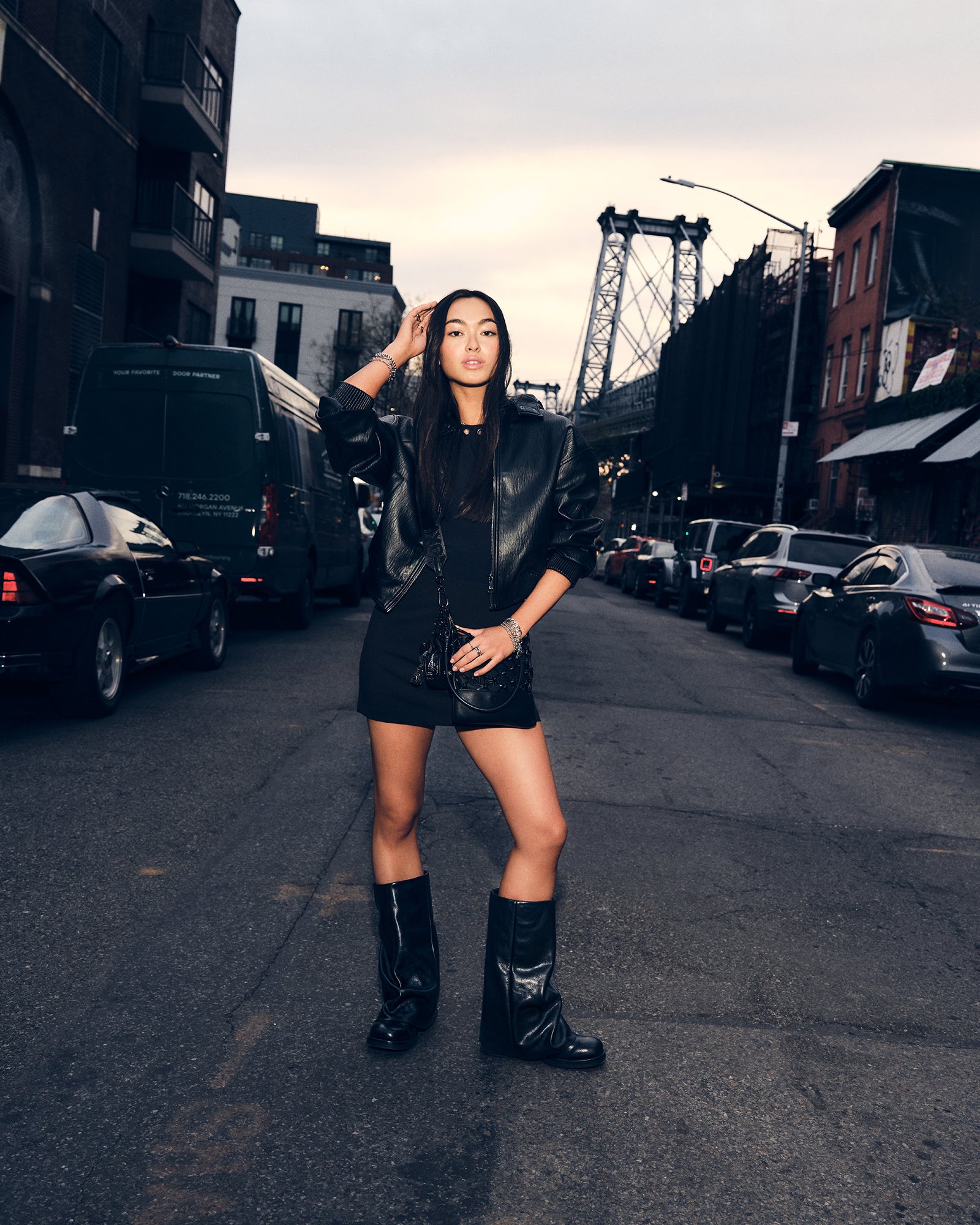 Side view of Benton cuffed boots in black leather against wooden flooring