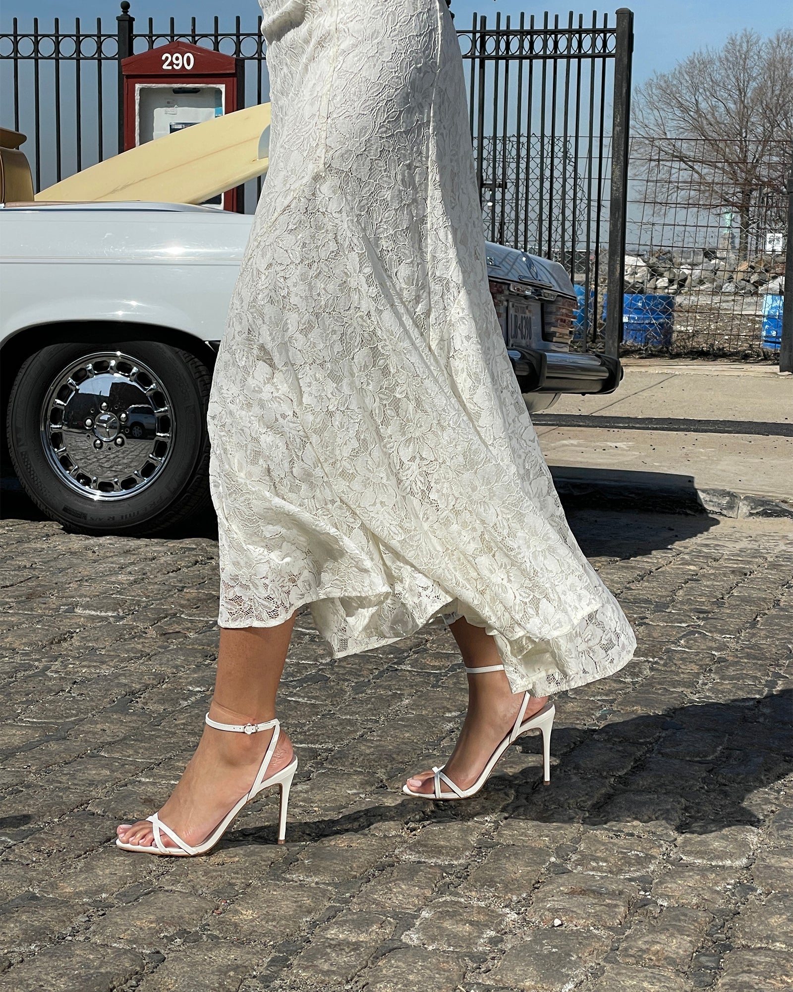 Side angle of white high heels highlighting the 4-inch stiletto heel