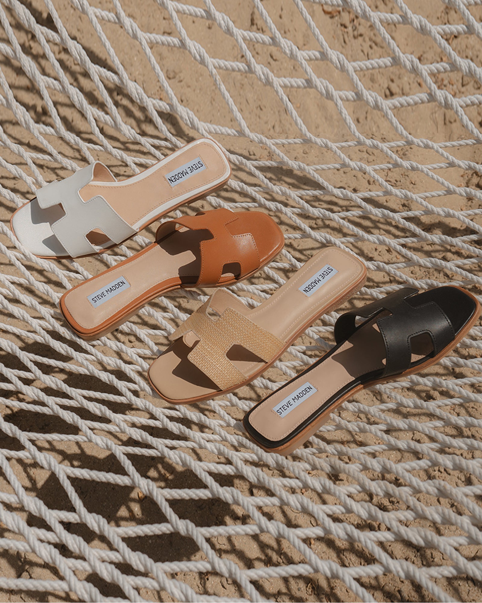 Side view of black leather sandals showing geometric strap cutouts