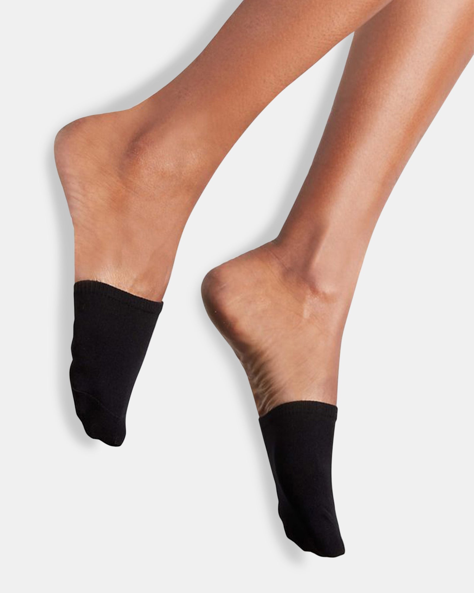 Black and tan no-show socks with partial toe coverage styled with sandals