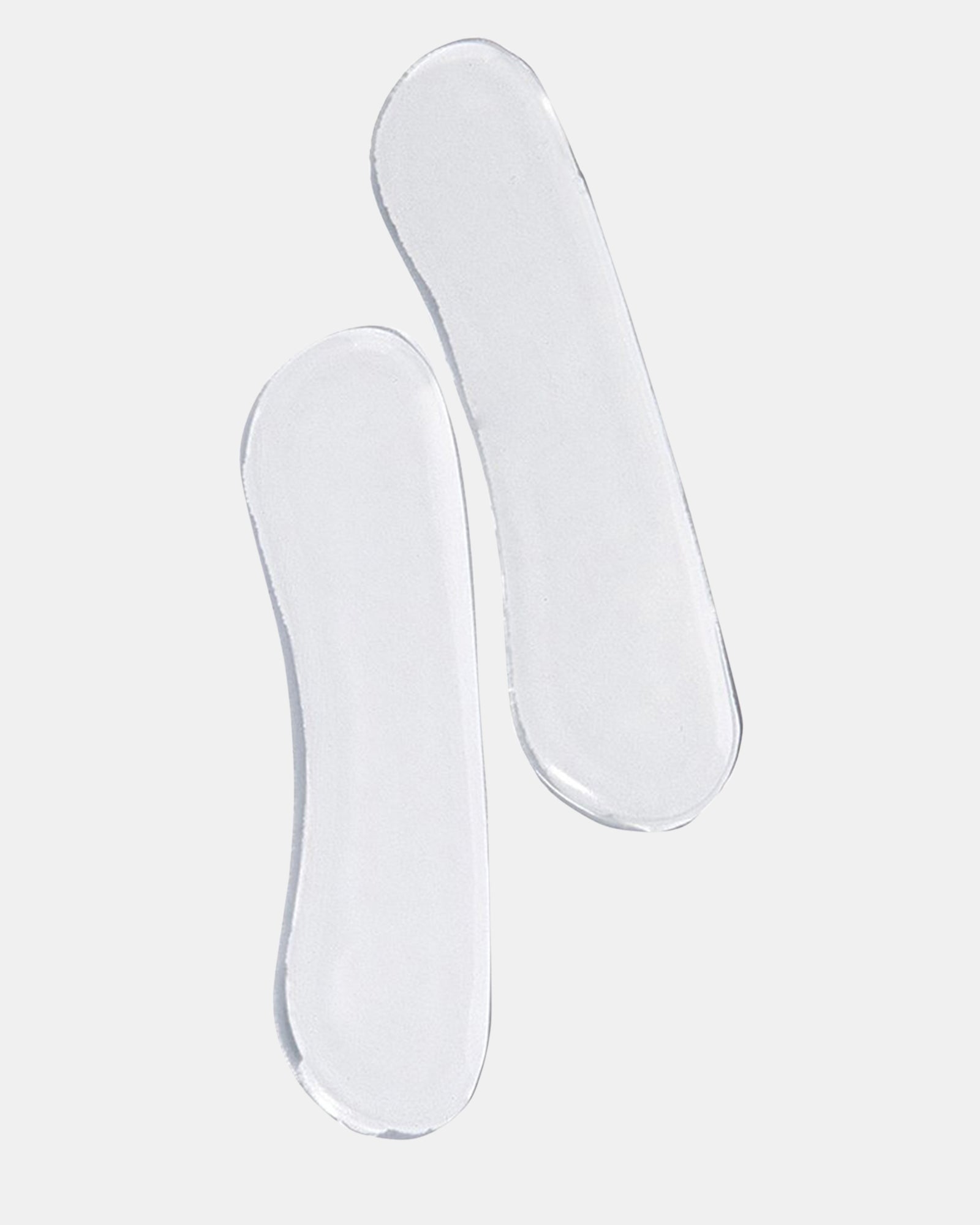 Top view of gel shoe inserts displayed alongside stylish footwear