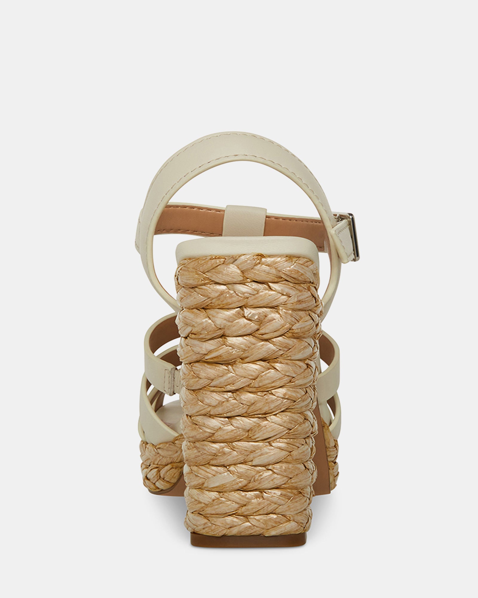 Close-up of block heel sandals highlighting buckle closure and textured raffia