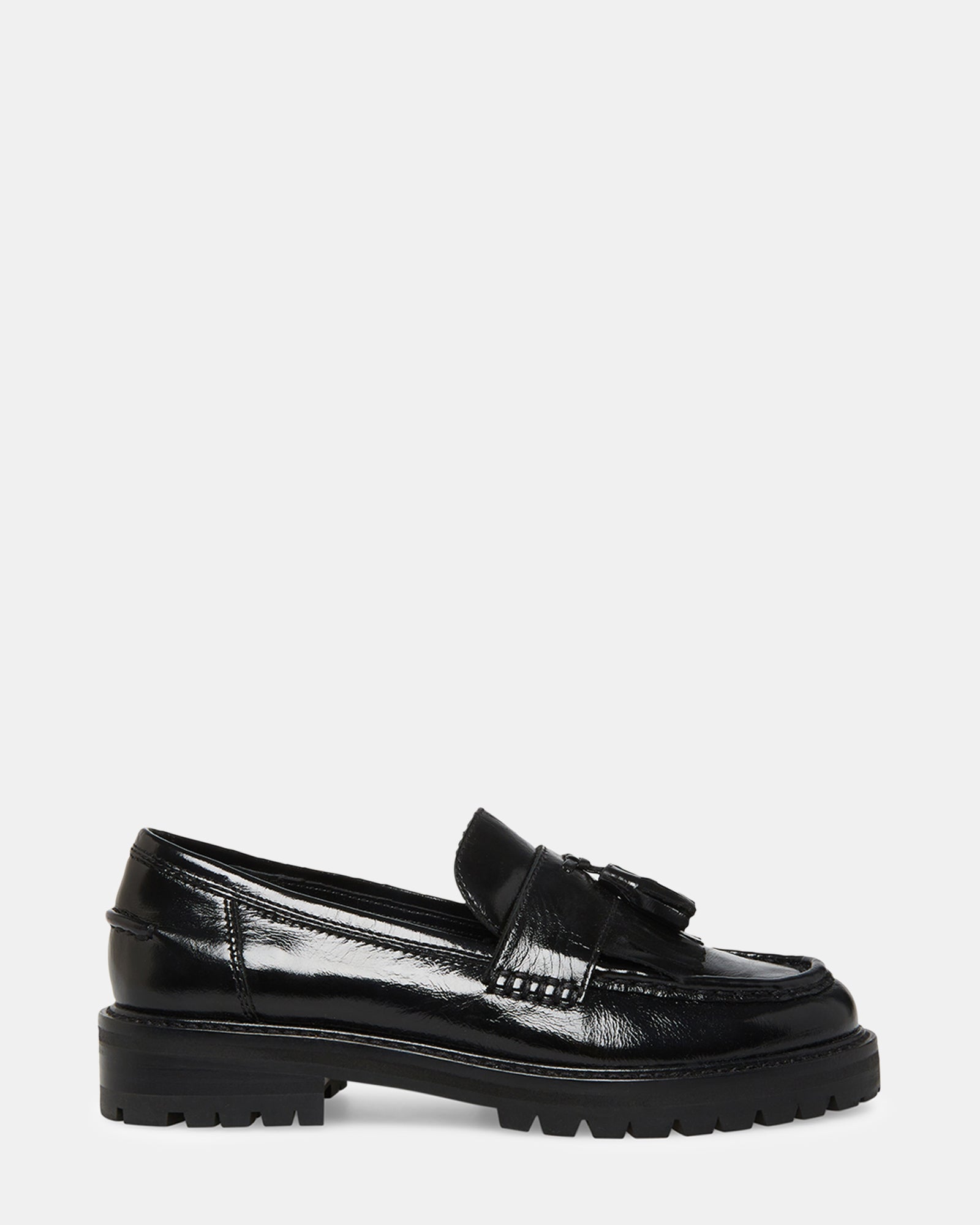Women's black leather slip-on loafers styled with cropped trousers