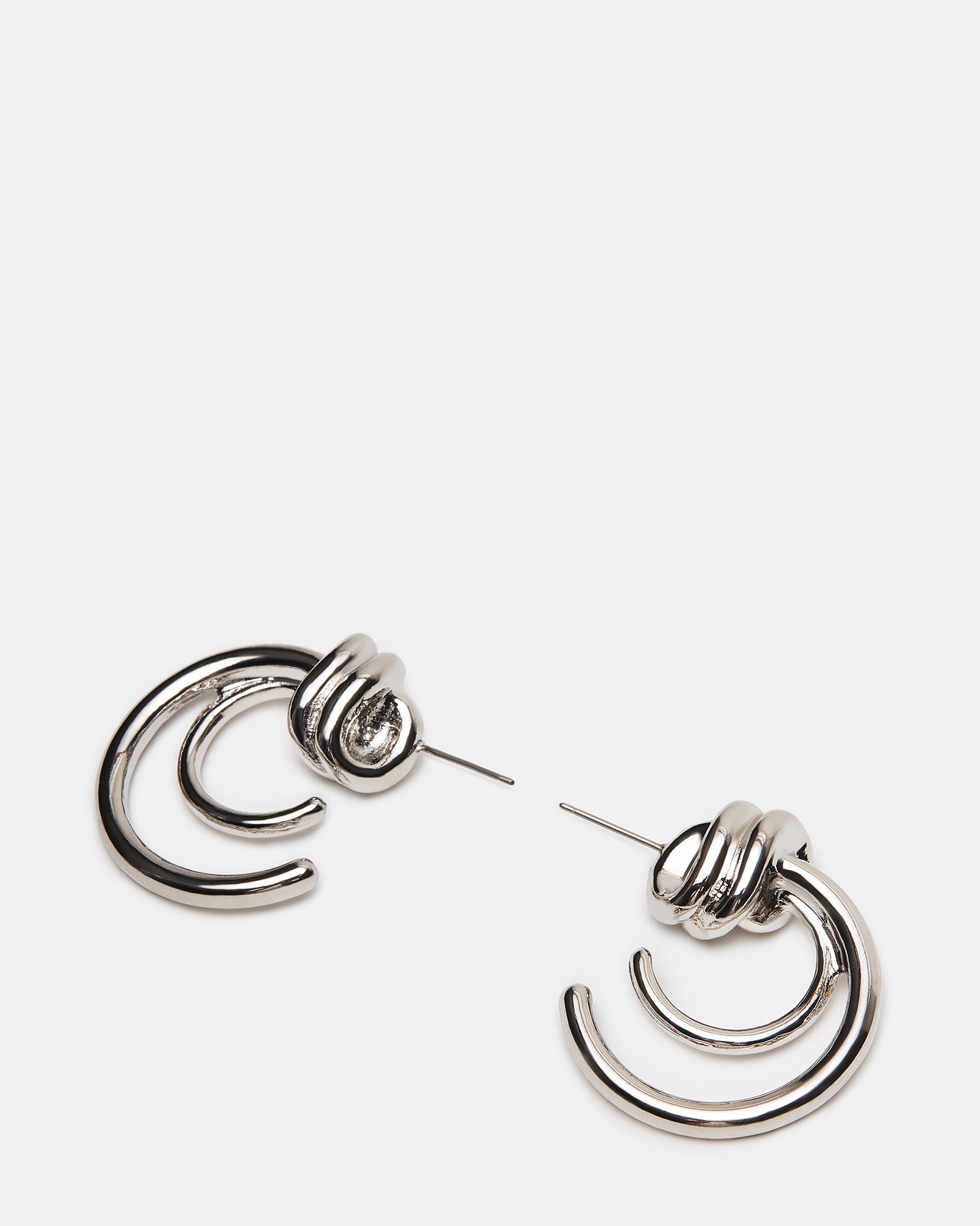 Side angle of hoop earrings showing push-back closure and knot texture in natural light.