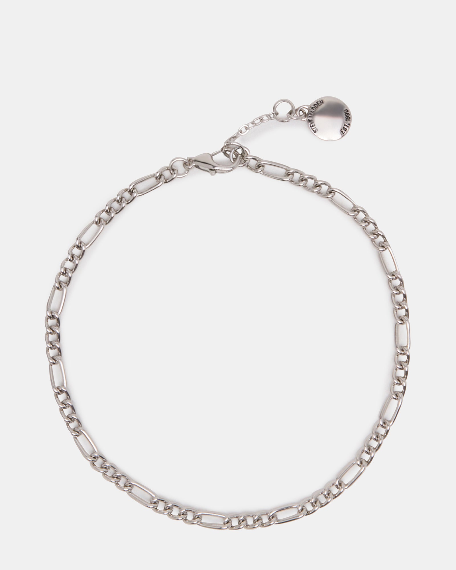 Silver Figaro chain anklet shown on ankle with beachwear