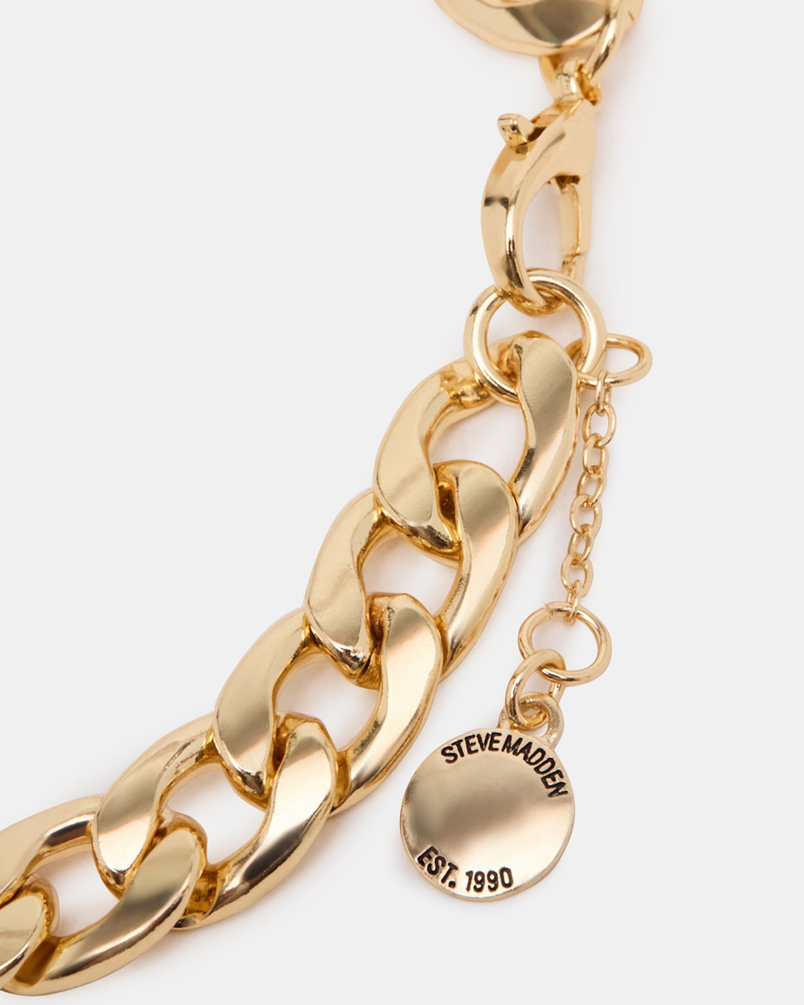 Close-up of link chain gold anklet anklet on ankle, worn with sandals