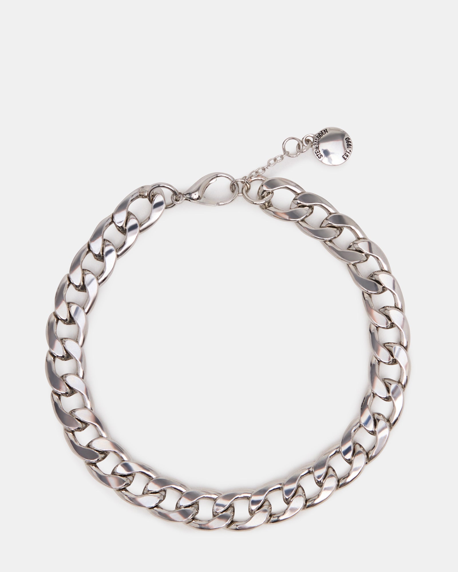 Close-up of the silver anklet silver on model’s ankle against light denim
