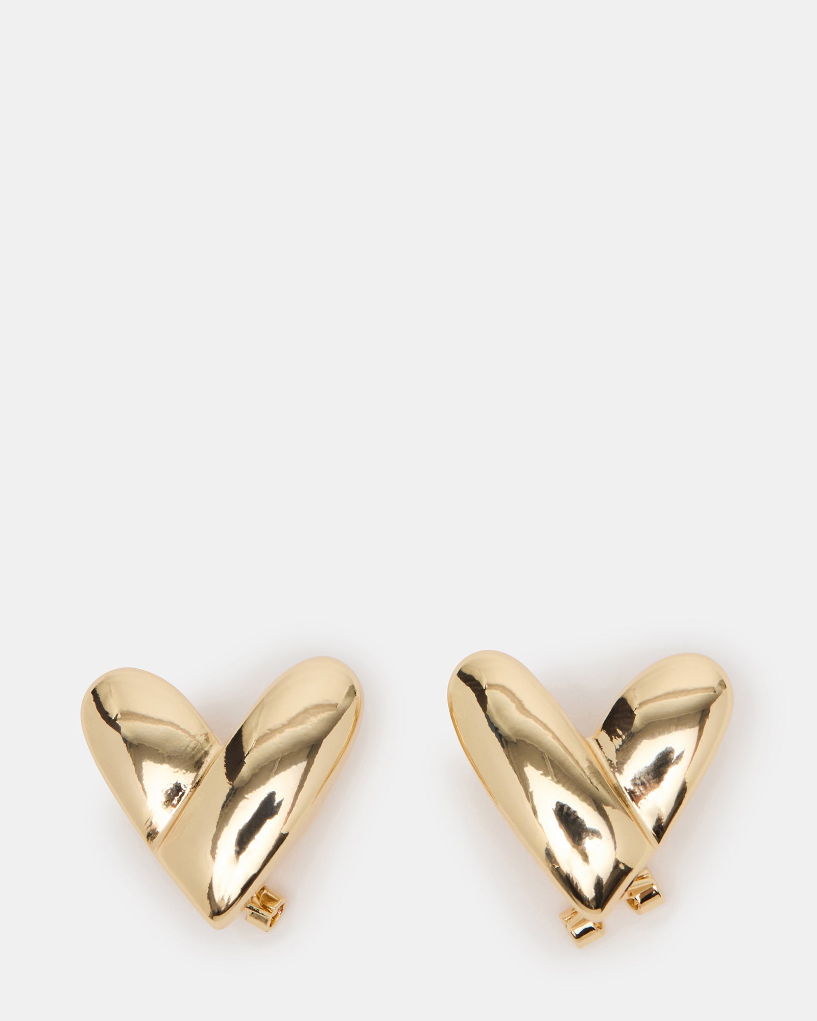 Close-up of 14k gold heart stud earrings showing intricate detailing