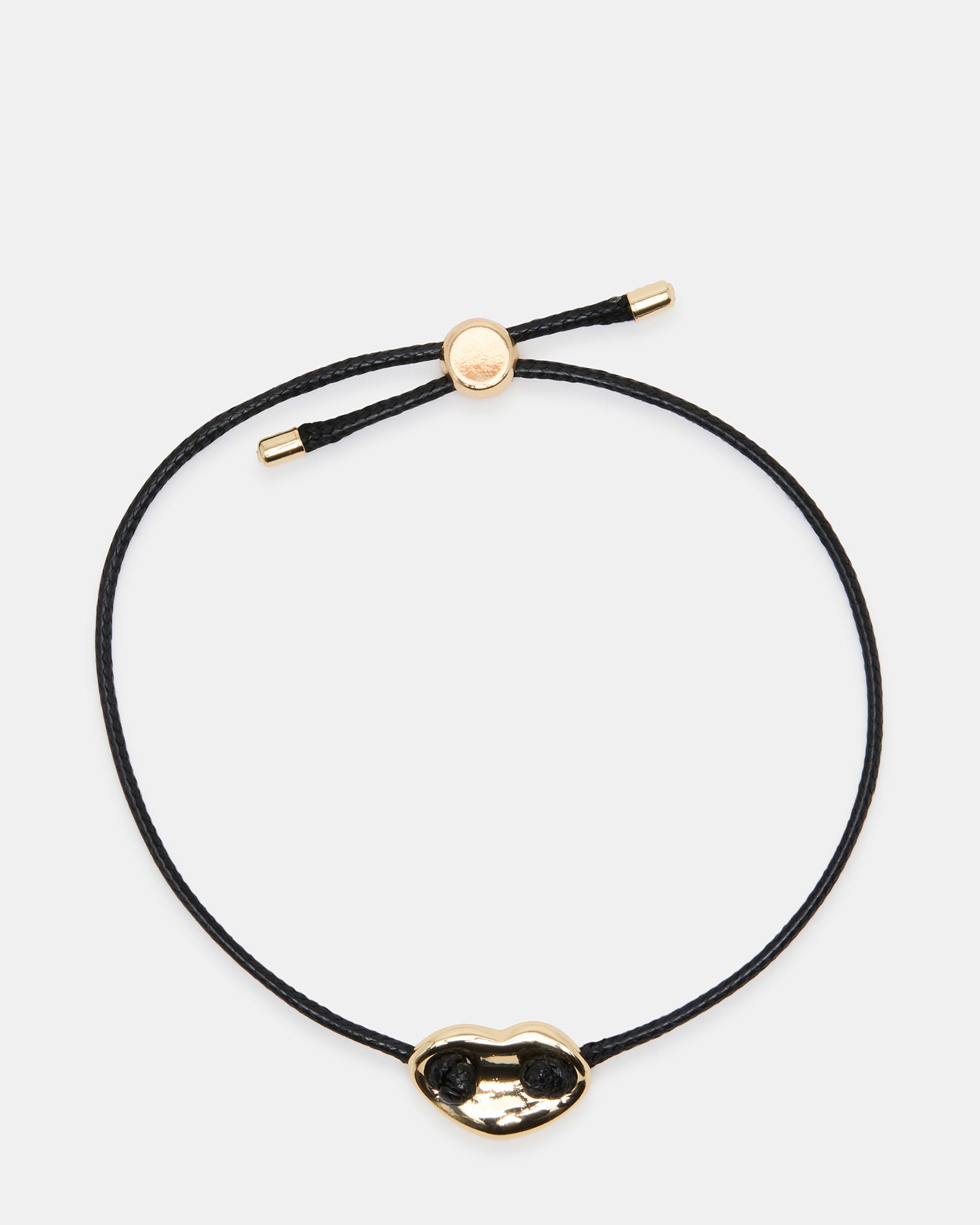 Close-up of black mariner friendship bracelet with gold details.