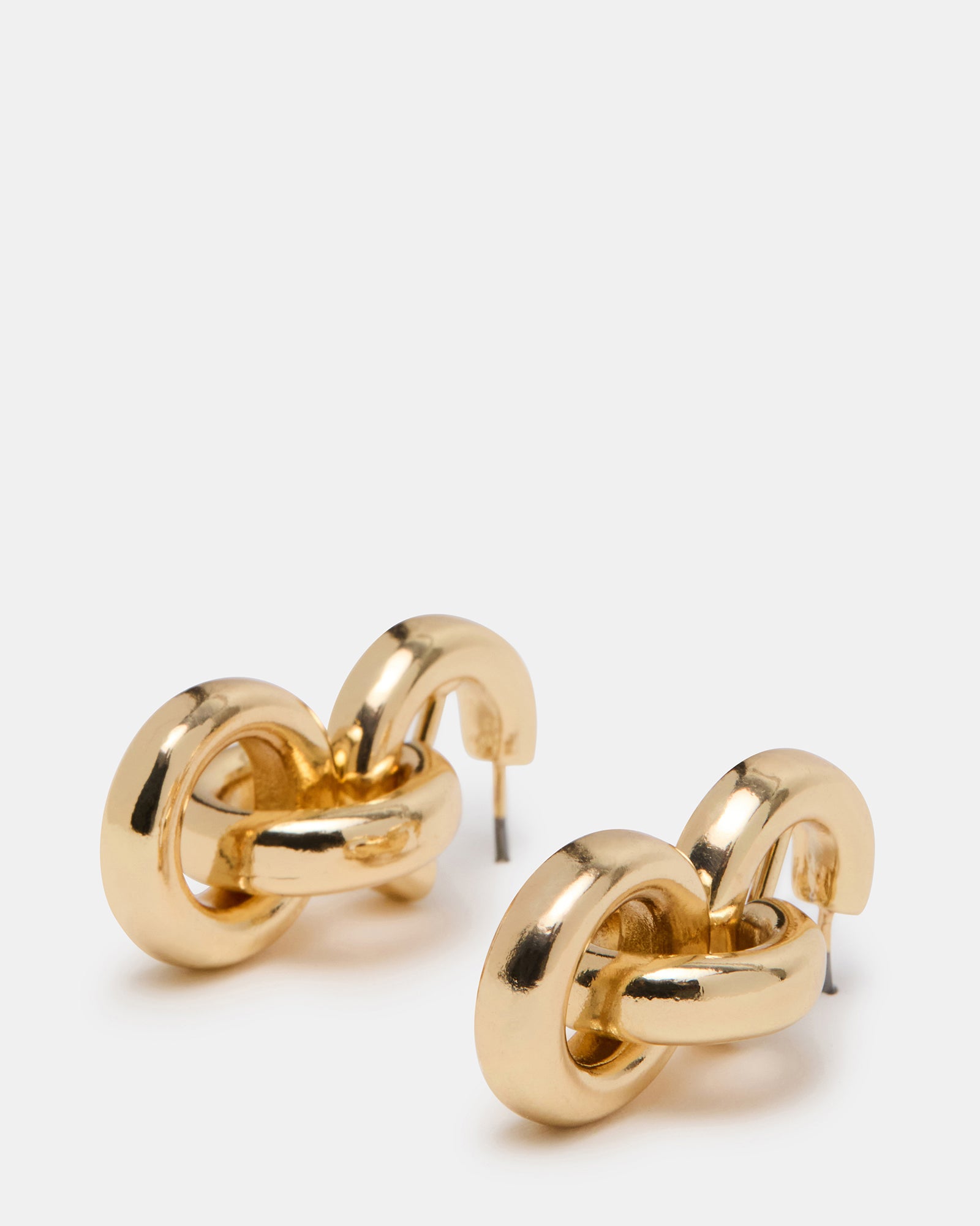 Model wearing lock earrings gold, styled with a chic evening outfit.