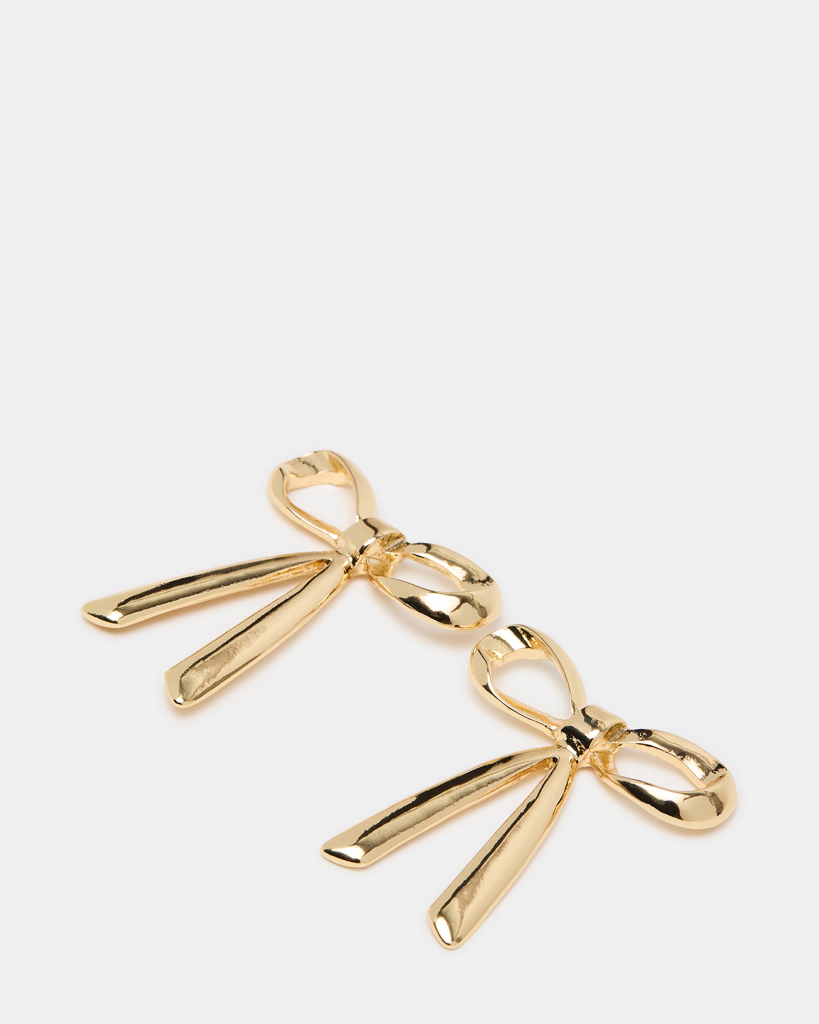 Close-up of gold bow earrings showing intricate design and post-back closure