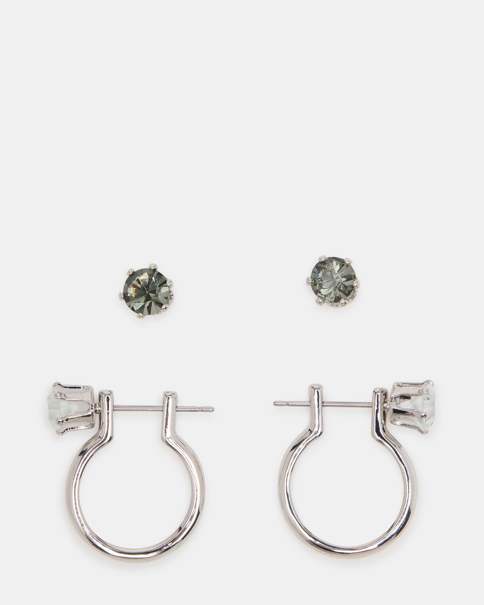 Close-up of silver huggie earrings with interchangeable crystal studs
