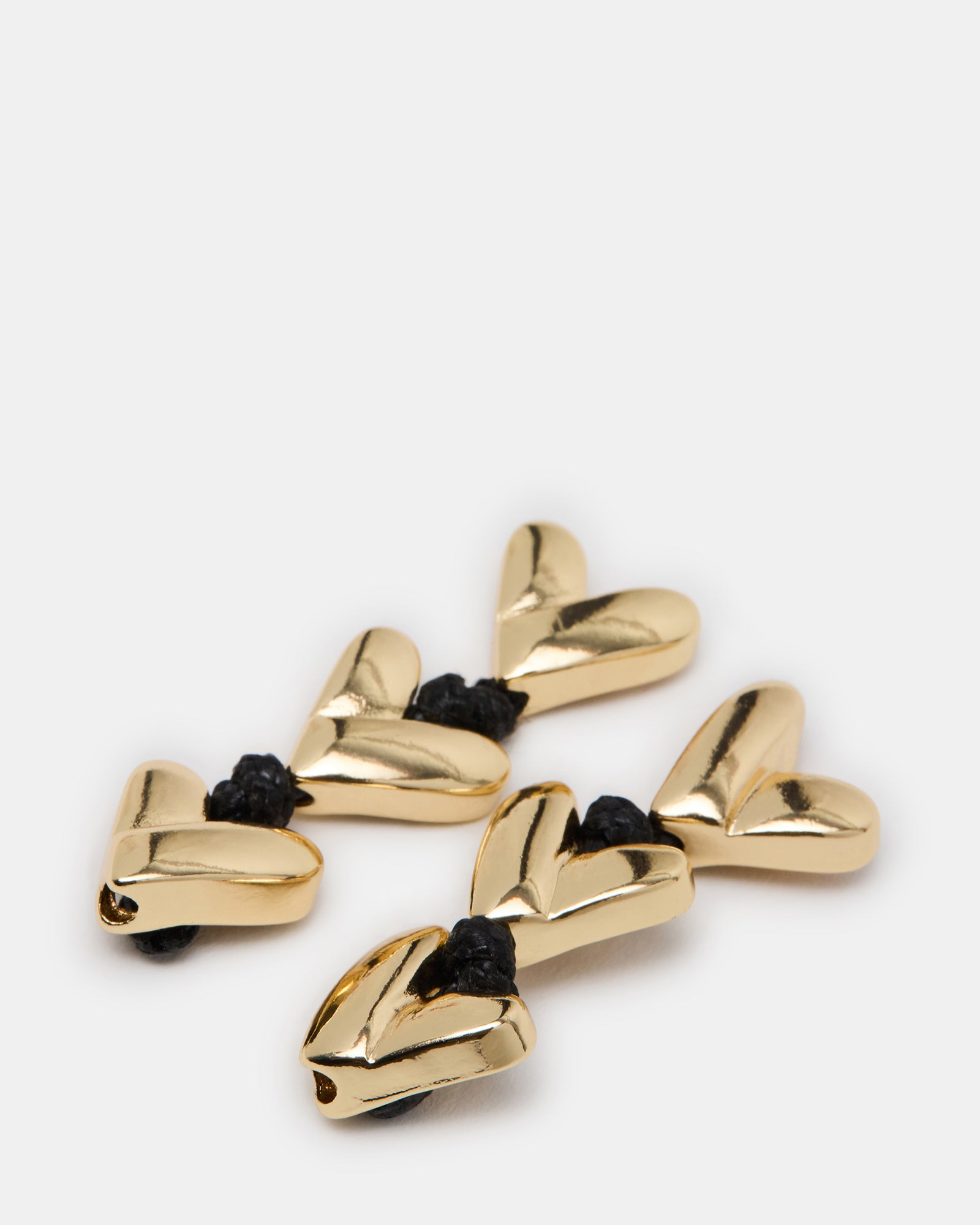 Close-up of gold finish heart earrings showing post-back closure and elegant style