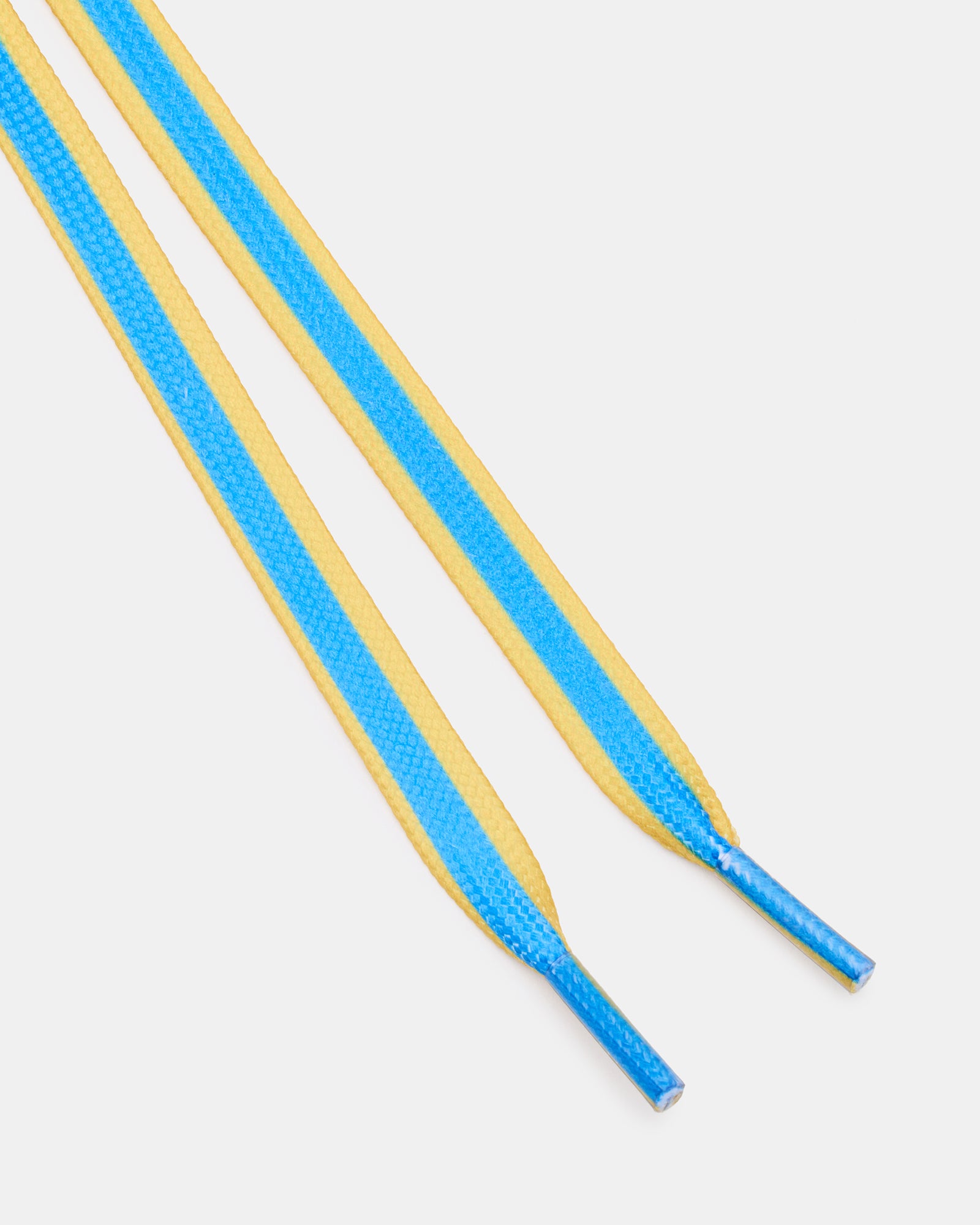 Stylish shoe charms on blue and yellow shoelaces