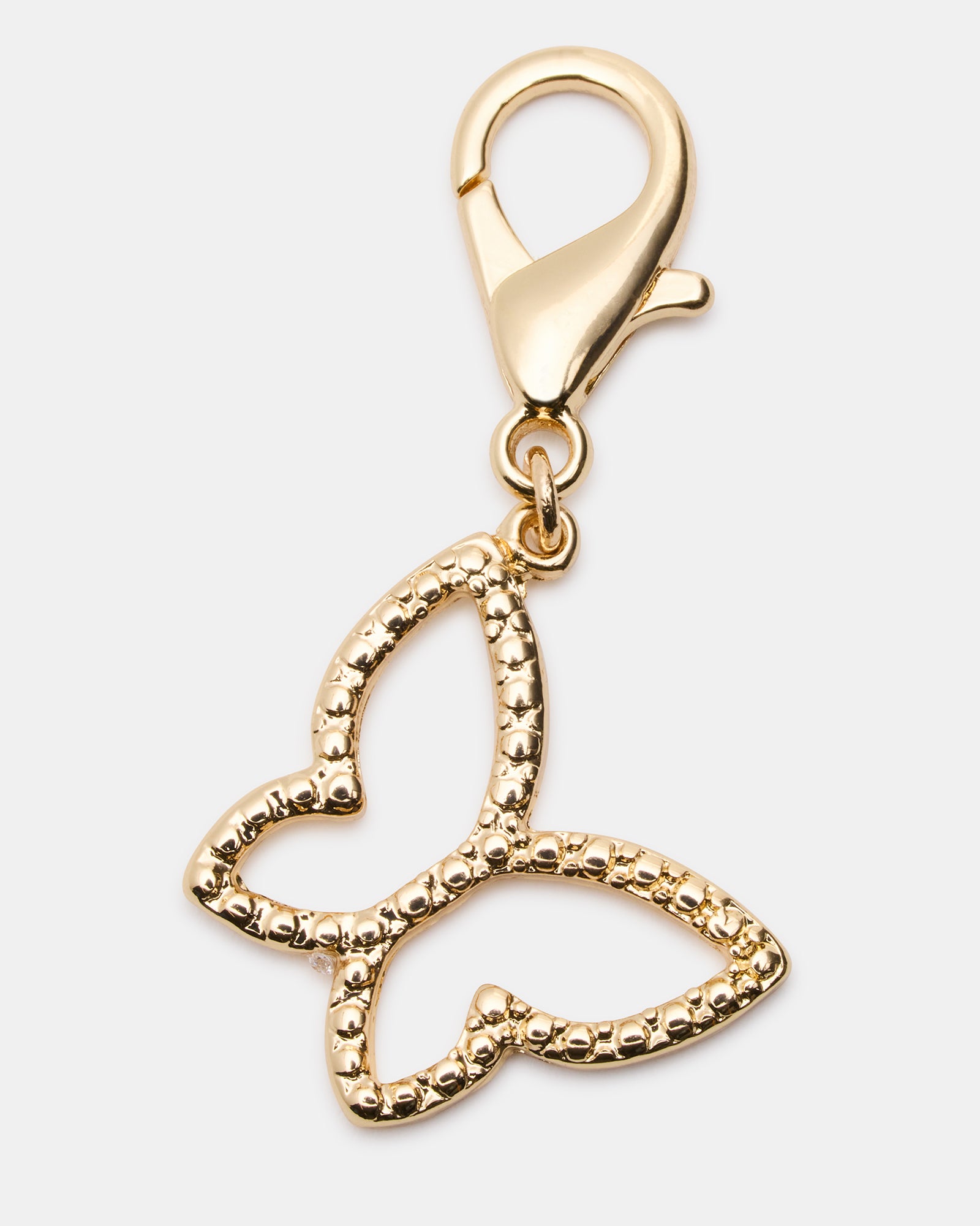 Close-up of shoe charm detail showing butterfly design and rhinestone sparkle
