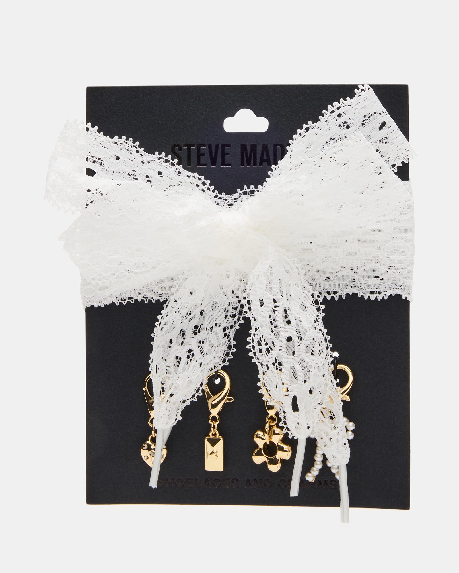 Close-up of charming white shoelaces with heart and flower charms.