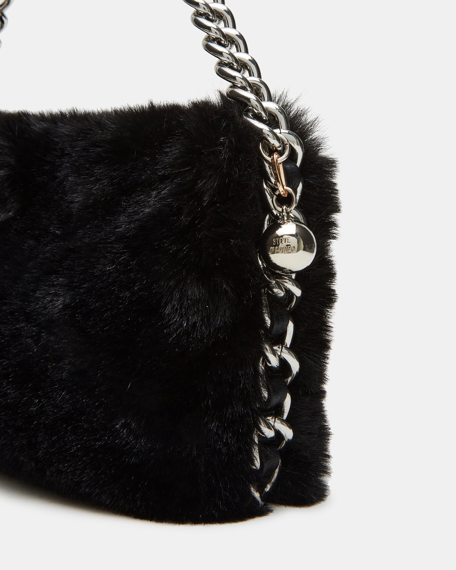 Model wearing the black bag with chain strap, demonstrating its versatility in a casual outfit.