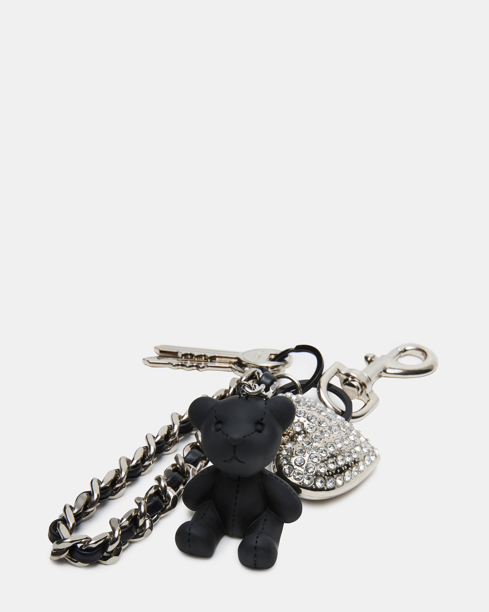 Rhinestone heart and bear charm attached to a stylish black handbag