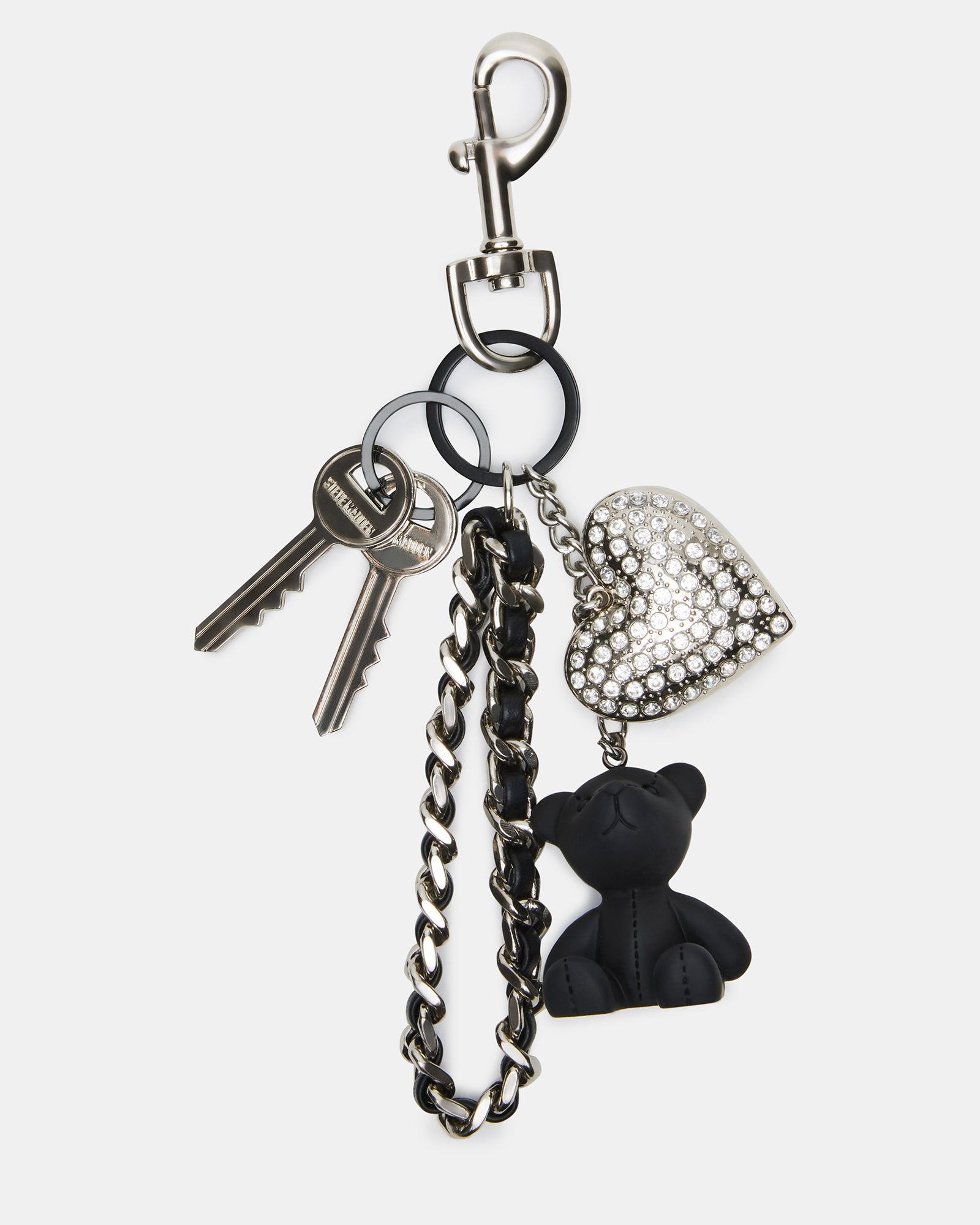 Rhinestone heart and bear charm attached to a stylish black handbag