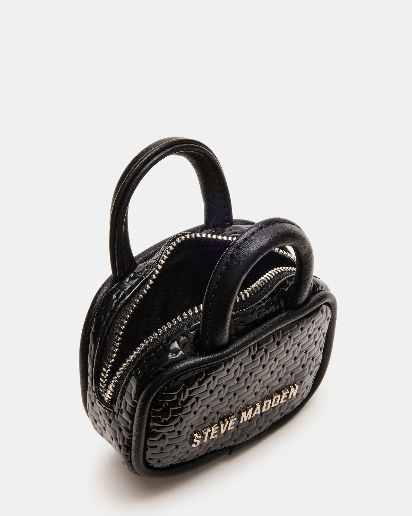 Cherry-accented zipper pouch of coach bag charm, displayed with headphones