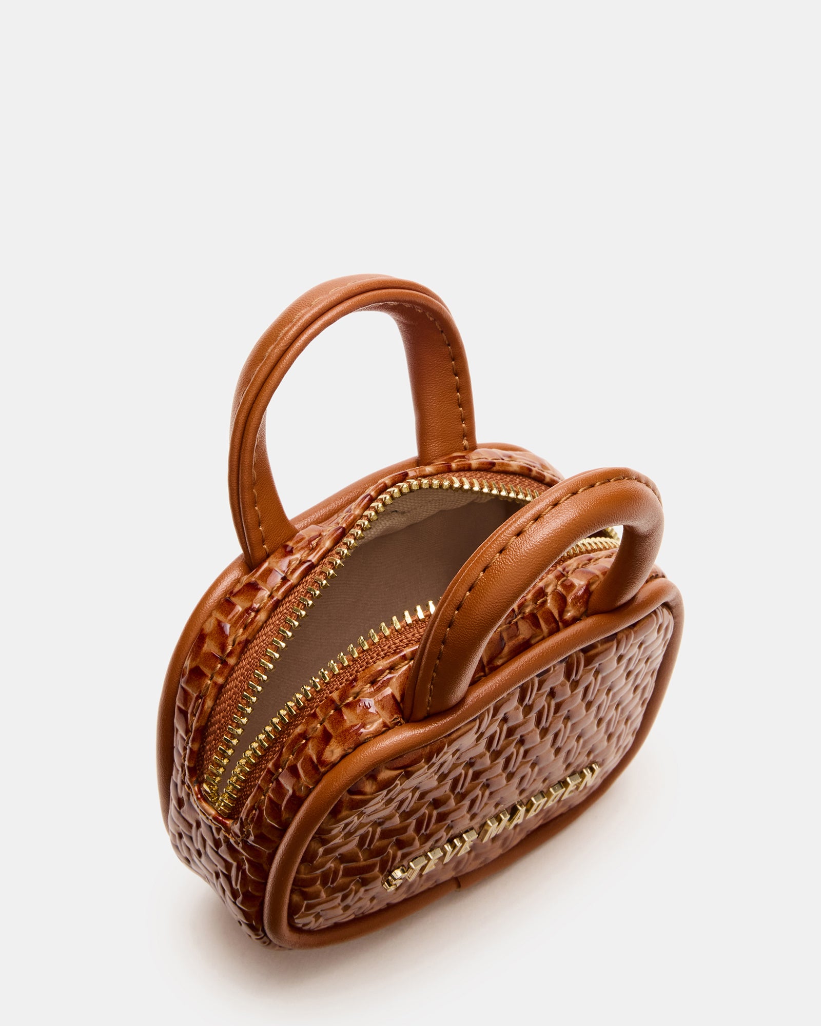 Flat-lay image displaying coach bag charm with headphones tucked inside